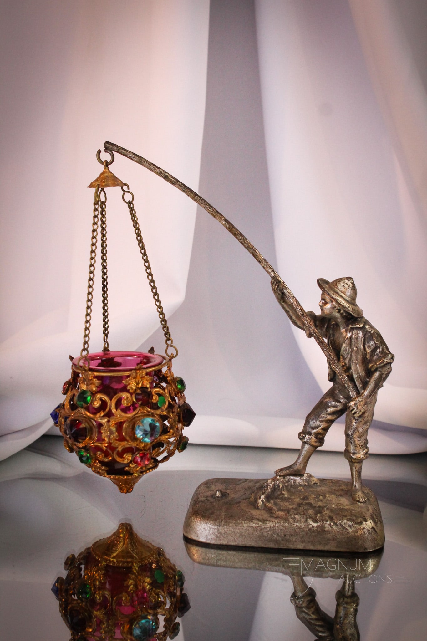 Victorian Figural Silverplate Jeweled Votive Fairy Lamp: Super piece of Victorian silverplate featuring a figural boy holding a lantern which is jeweled with a cranberry insert. Amazing piece. This little fairy lamp charmer measures 8 1/2" tall, 8" wide.
