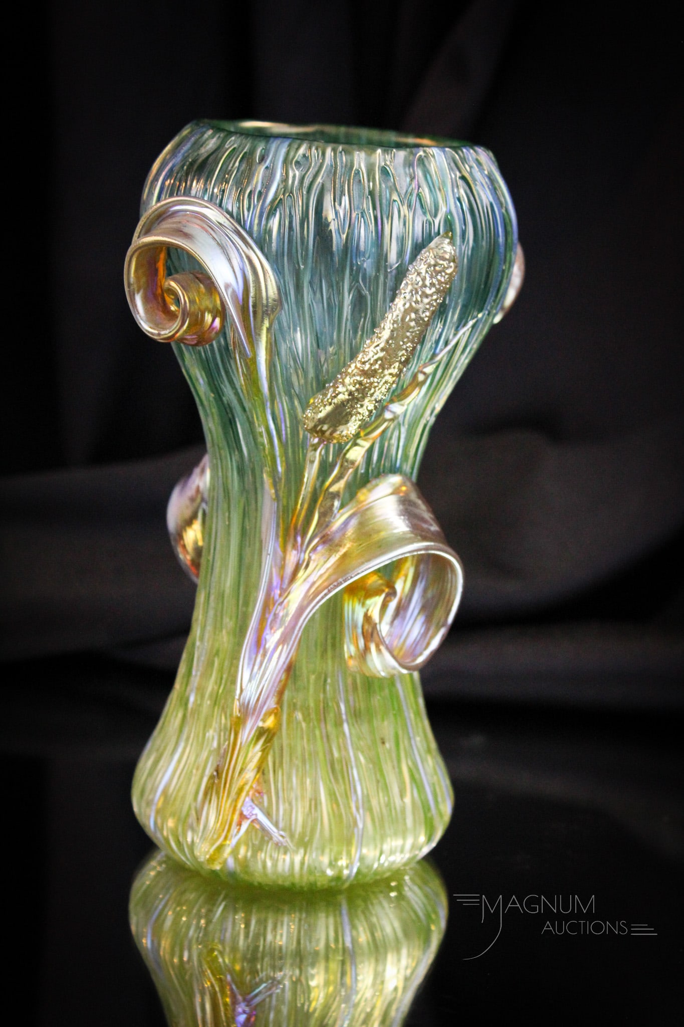 Loetz Texas Cattails Irridescent Art Glass Vase: Great colored example of a Loetz "Texas" cattail adorned irridescent glass vase. Vase measures 8" tall. One area of loss to the edge of the cattail leaf as shown.