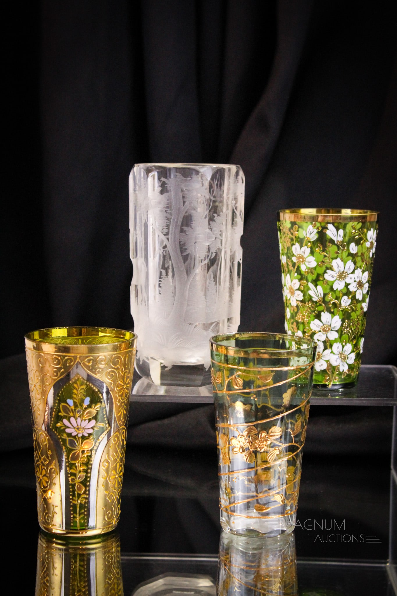 4 piece lot Moser Bohemian Glass Victorian Enameled & Engraved Tumblers: Four fine examples of art glass tumblers of Moser or Bohemian origina. Three are gilt and enameled. One is engraved with a forest scene with deer.
