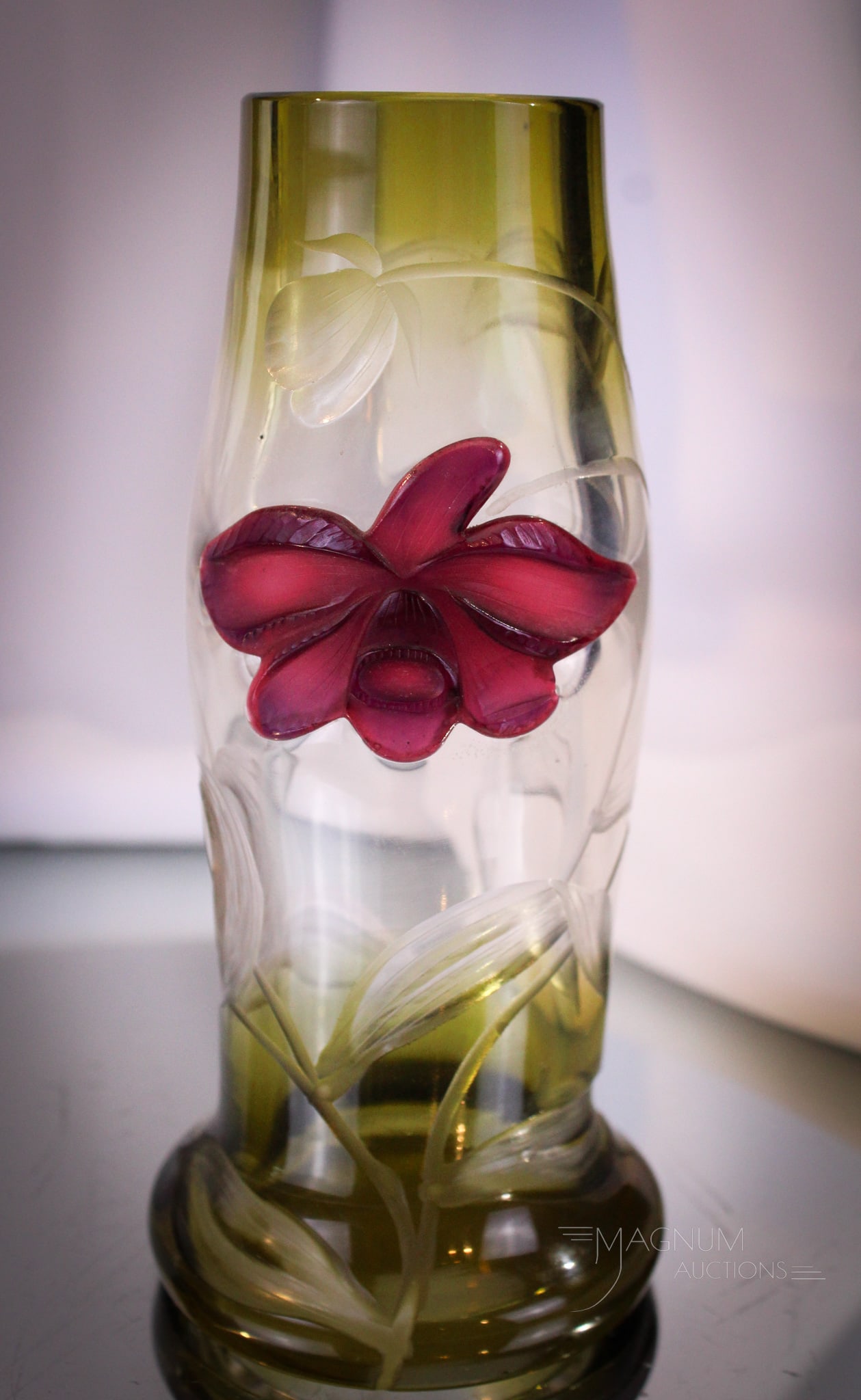 Signed Moser Karlsbad Intaglio & Marquetry Art Glass Vase: Gorgeous signed Moser Karlsbad intaglio and marquetry carved art glass vase. Vase with green to clear coloring and crimson flower. Measures 6" tall.