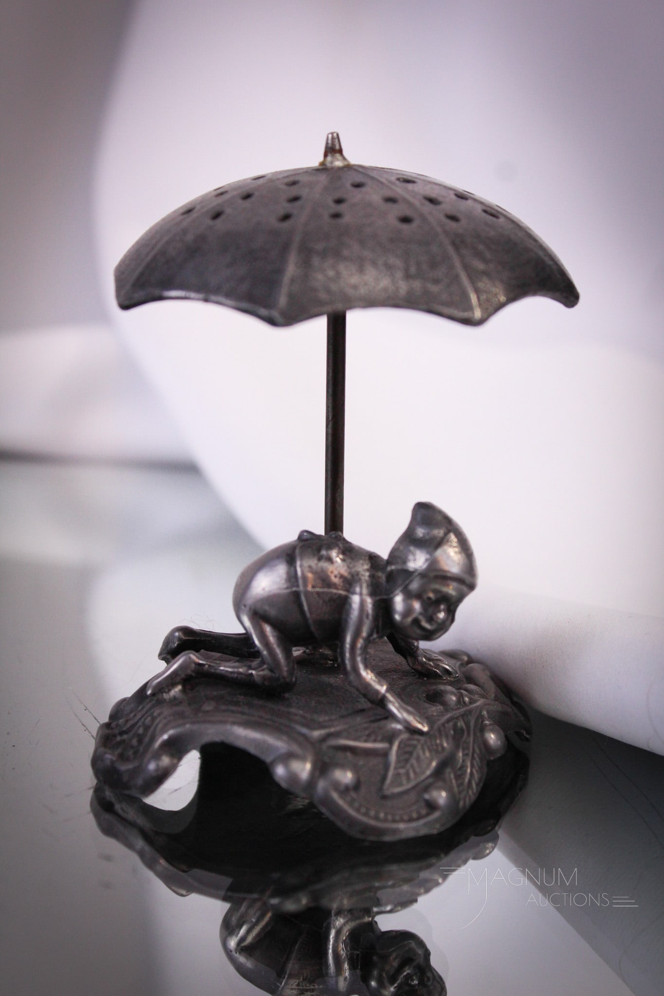Pairpoint Silverplate Palmer Cox Brownie with Umbrella Toothpick Holder: Pairpoint silverplate at it's best with this Victorian Palmer Cox Brownie example with umbrella. This little toothpick holder measures 3" tall and features a brownie crouched on all fours. No telling