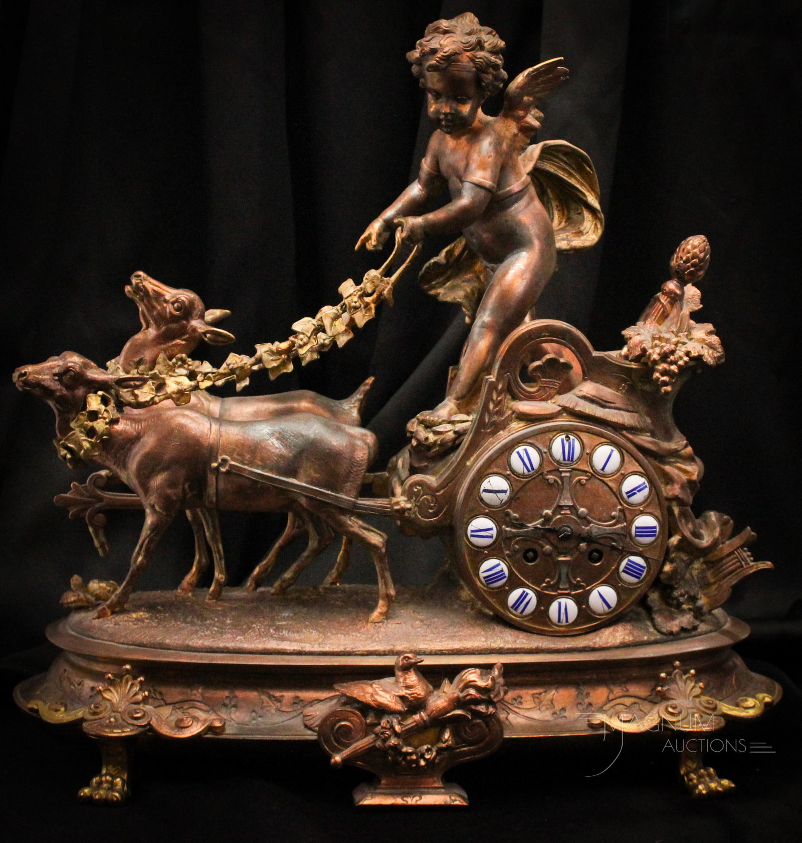 Massive 17" Victorian French Cherub & Chariot Gilt Mantle Clock: Important French gilt figural mantle clock featuring a cherub in a chariot along with two deer. Reigns are garlands of florals. Torch scepter in the chariot a shown. Fantastic piece! Clock measures 17