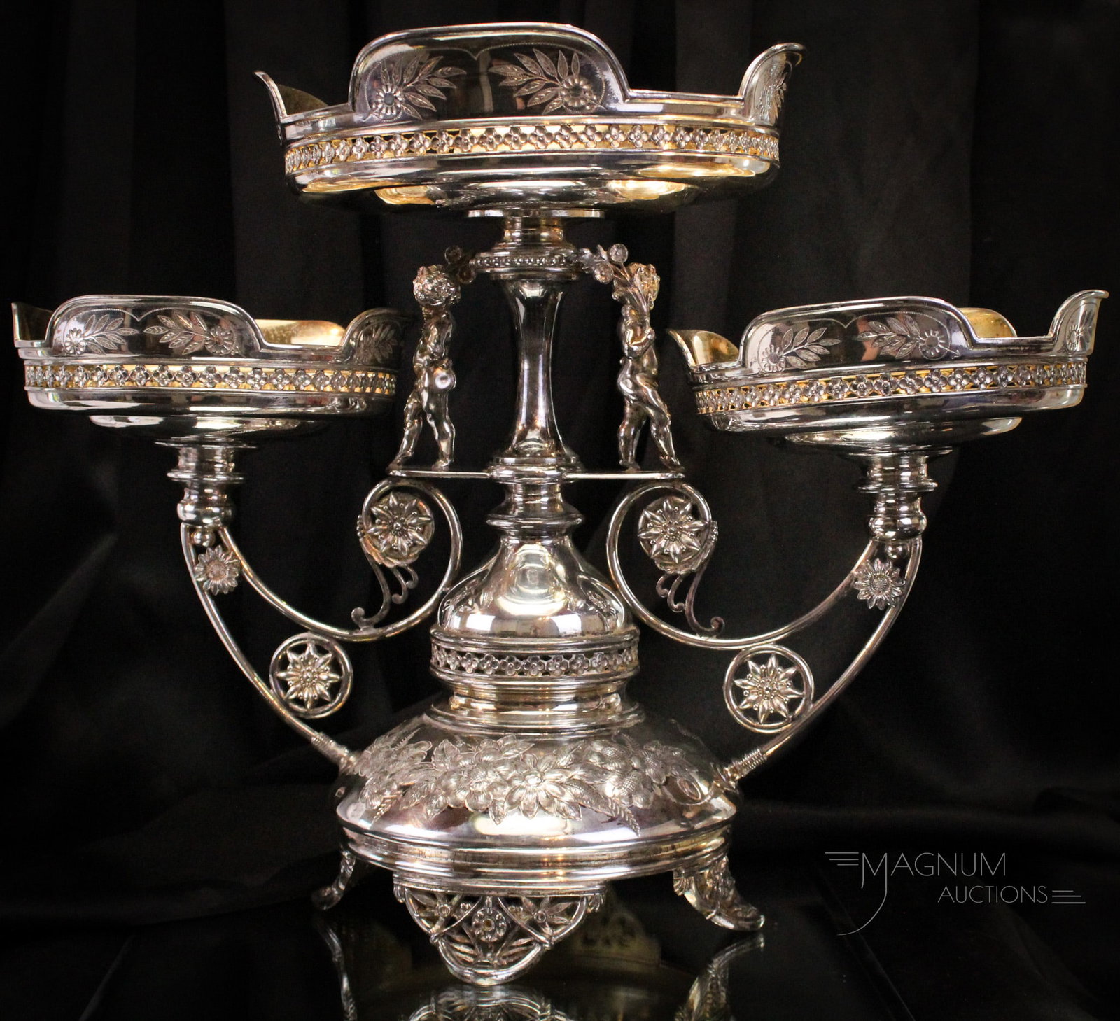 Victorian Simpson Hall & Miller Silverplate Figural Cherub 19 1/2" Centerpiece: Fine signed Simpson Hall & Miller Victorian silverplate centerpiece featuring figural cherubs at the supports. This large piece of Victorian silverplate is a welcome addtion to any dining table. It me