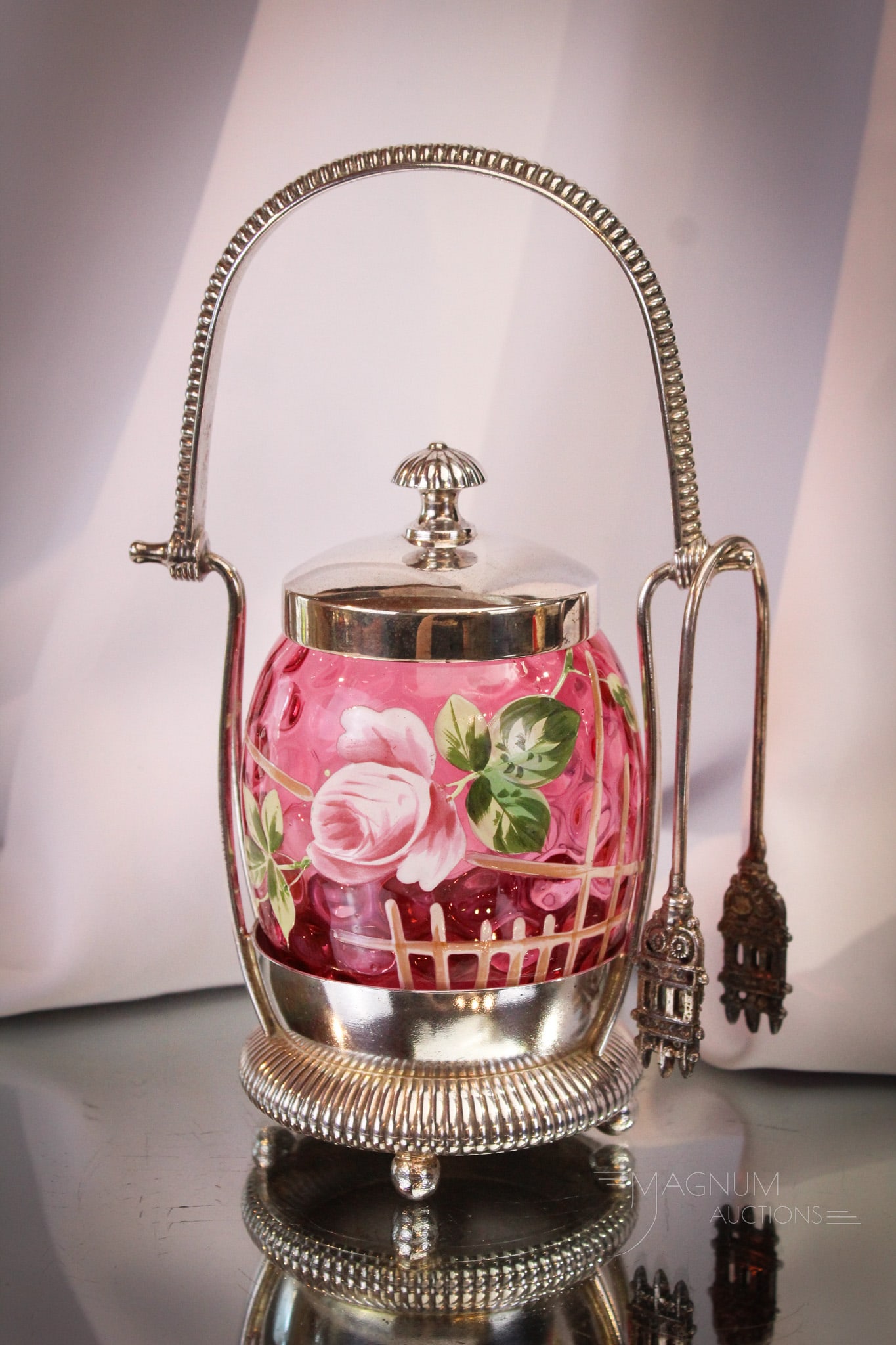 Webster Silverplate Cranberry Enameled Victorian Pickle Castor: Wonderful cranberry enameled Victorian pickle castor. Frame is signed Webster silverplate. Jar is elaborately decorated with roses and trellis decoration. Fine example that could be yours! Castor meas