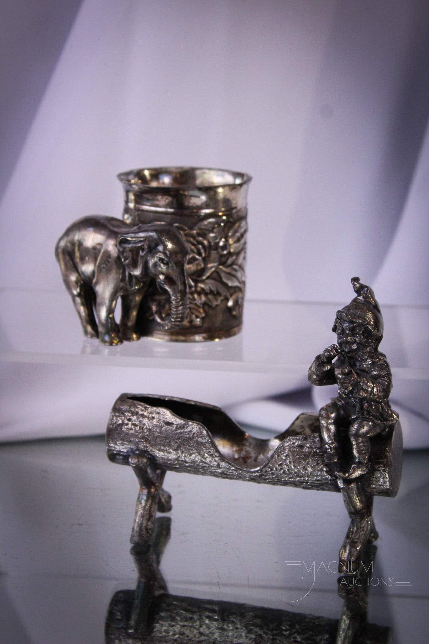 Tufts & More Victorian Silverplate Figural Toothpick Holders: Two select examples of Victorian silverplate toothpick holders featuring a gnome on a log and also an elephant. The elephant is signed Tufts. Tallest measures 4".
