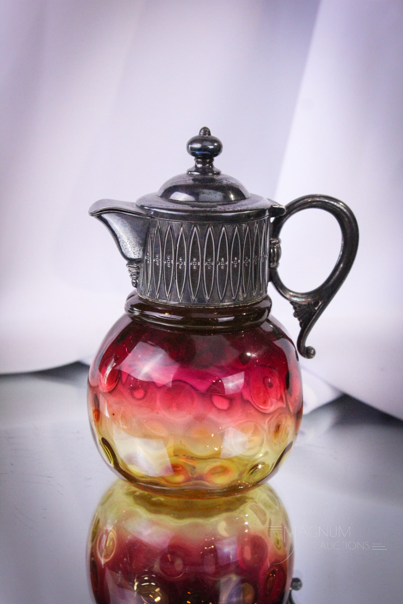 Victorian Mt. Washington Amberina Syrup Pitcher: Excellent example of a Mt. Washington Victorian diamond quilt syrup pitcher. This piece with original top. Perfect coloring. Syrup measures 5 1/2" tall. Provenance: This item is from the private colle
