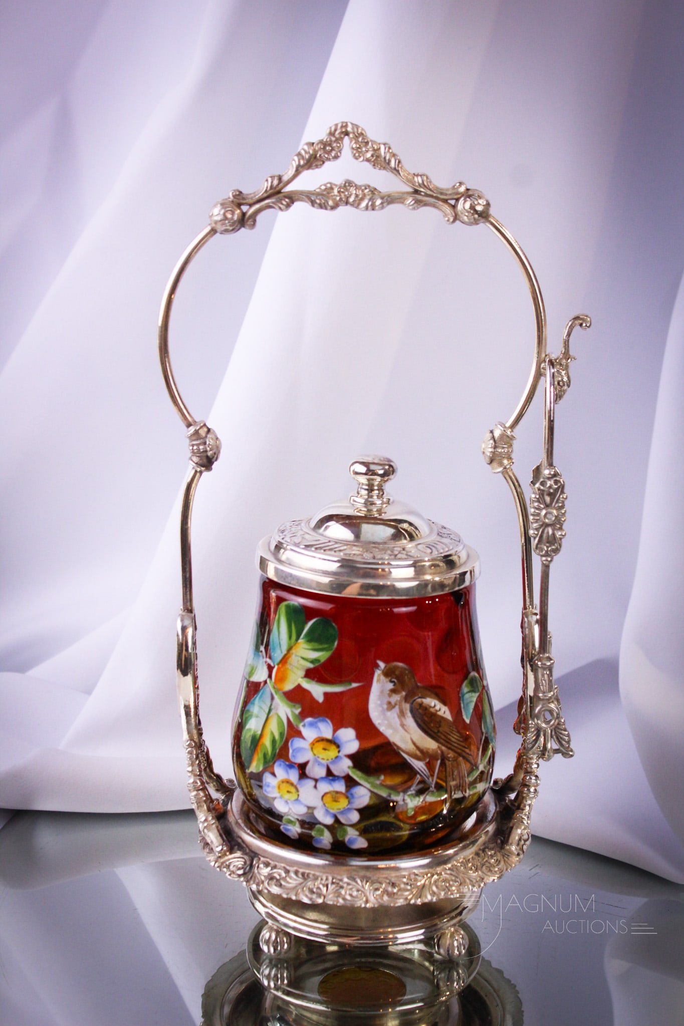 Homan Silverplate Victorian Amberina Bird Enameled Pickle Castor: Fine offering of an attractive Victorian Homan signed silverplate pickle castor complete with enameled with bird on flowering branch amberina glass insert. Castor measures 12" tall.