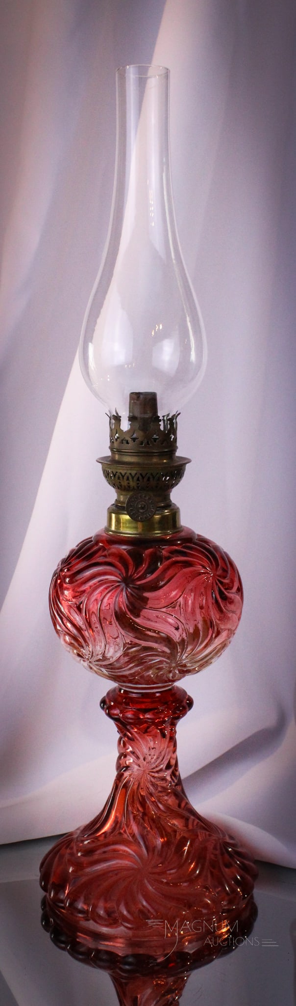 Baccarat Rose Tiente Swirled French Art Glass Oil Lamp: Wonderful find in this Baccarat Rose Tiente colored pinwheel swirl pattern stand oil lamp. Lamp measures 9" tall to the burner collar. Lamp is unsigned.