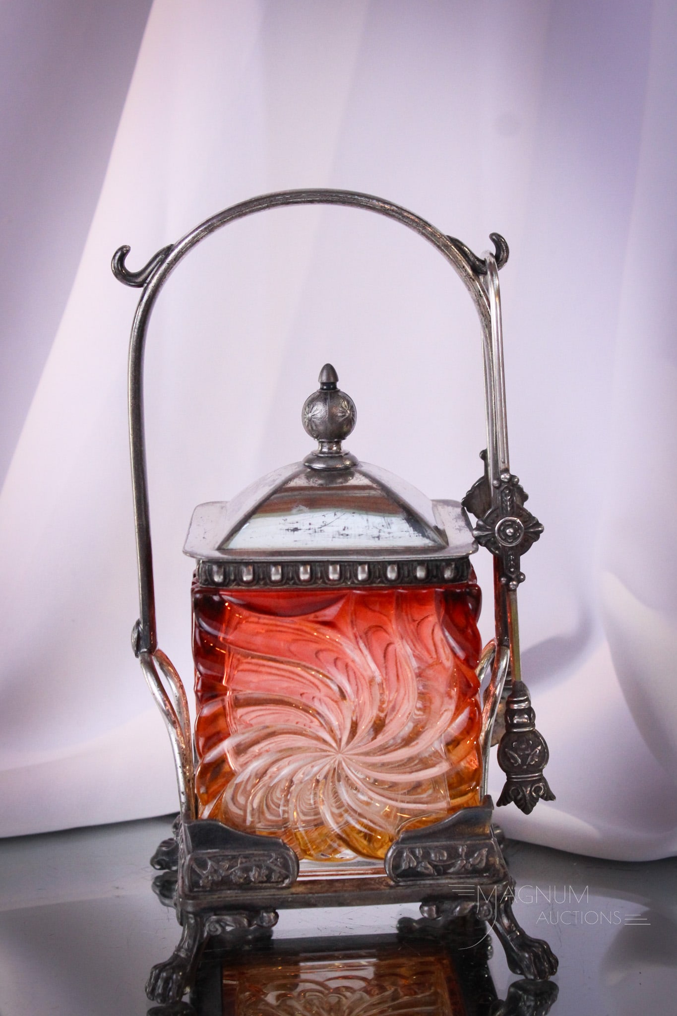 Reed & Barton Silverplate Baccarat Rose Tiente Pinwheel Swirl Pickle Castor: Rare find in this square form body Baccarat Pinwheel Swirl Rose Tiente colored pickle castor jar set in signed Reed & Barton silverplate holder. This castor comes complete with original lid. It measur