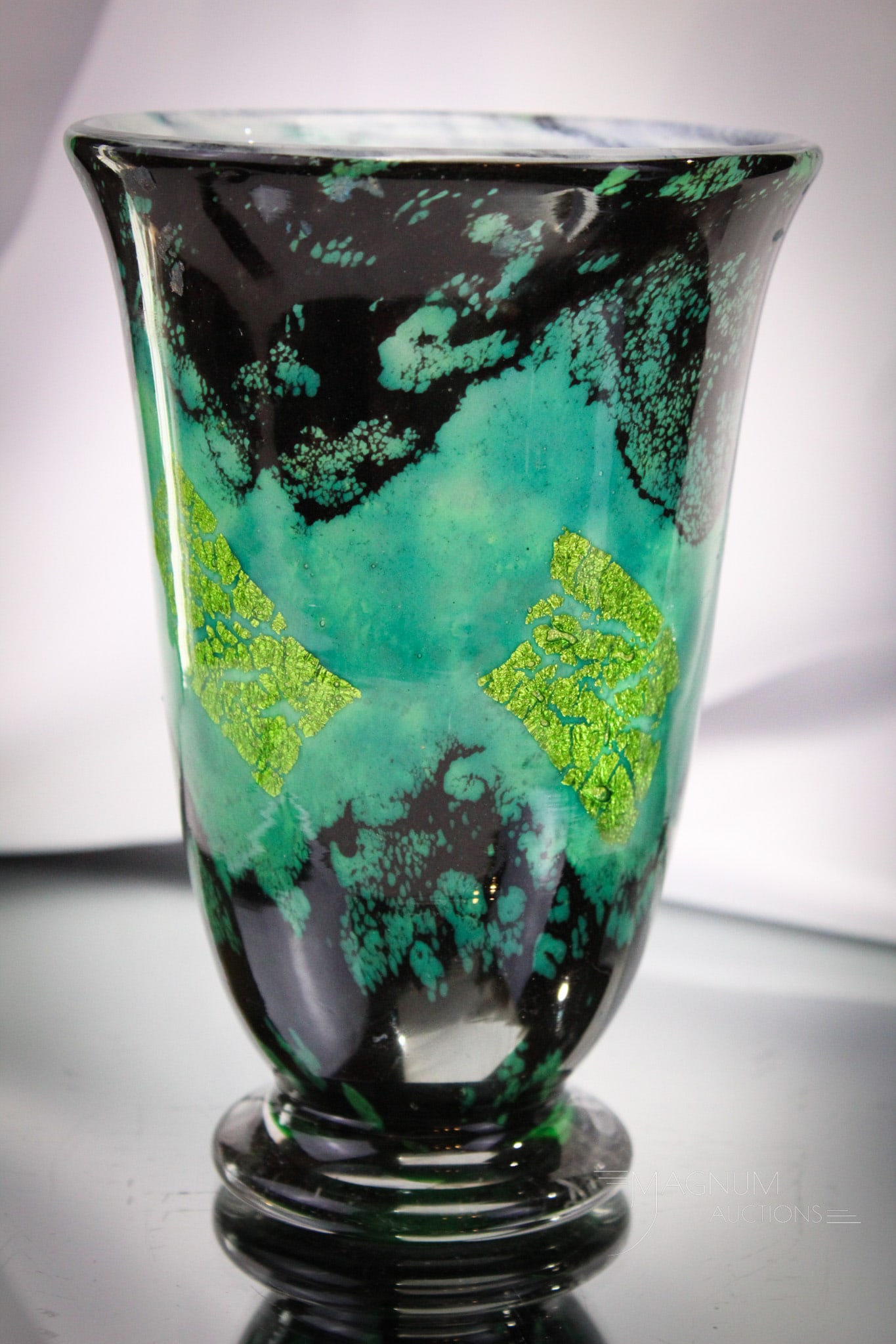 Signed Daum Nancy Art Deco Period French Art Glass Vase: Beautifulo Art Deco period signed, "Daum Nancy" French art glass multi-layered vase. This example in greens, blues, and black. Vase has exploded gold leaf embedded in the layers. Piece measures 7" tal
