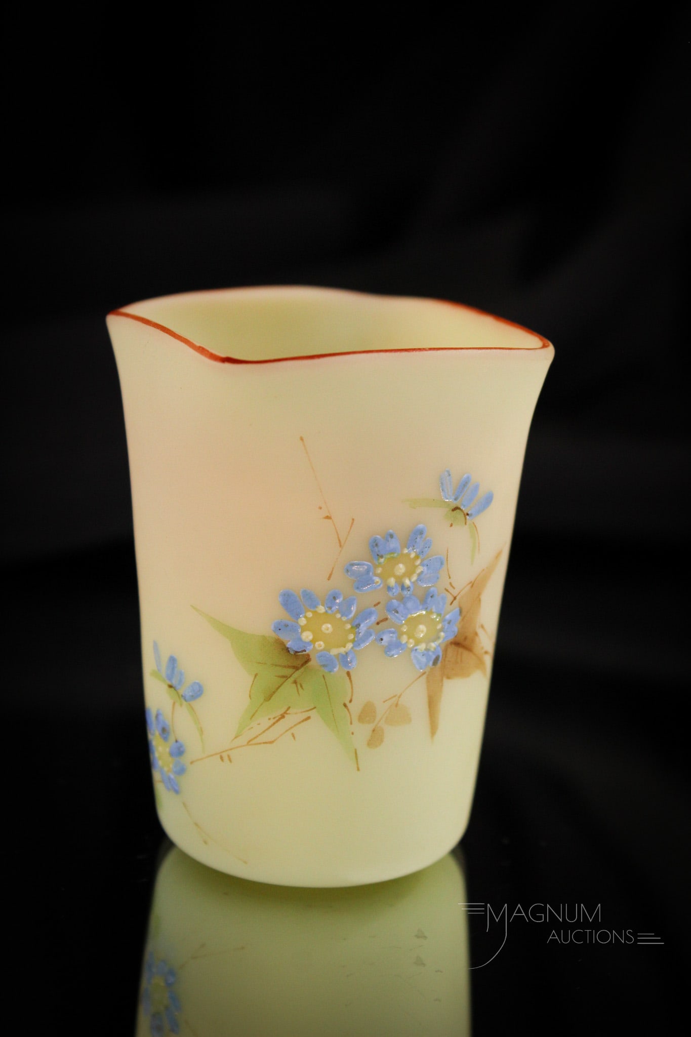 Mt. Washington Bumese Victorian Glass Toothpick Holder: Delicate blue flowers adorn this fine Mt. Washington Victorian toothpick holder in burmese glass.This one measures 2 3/4" tall. Provenance: This item is from the private collection of Eileen Flaks. E