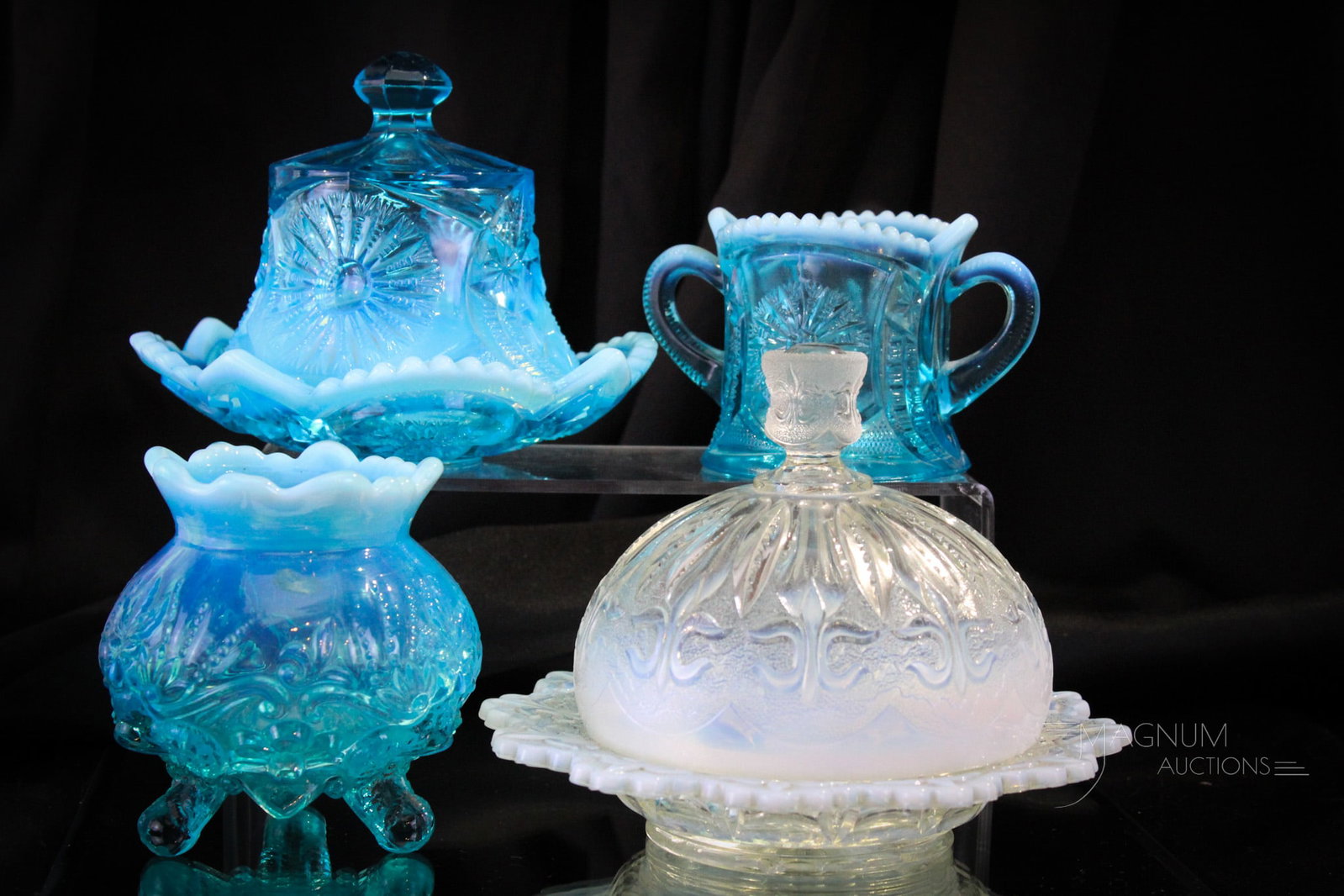 4 pc Lot Victorian Opalescent Northwood & More Glass: Four sought after examples of Victorian opalescent glass. This lot is comprised by a Jefferson Iris with Meander covered butter, a blue Sunburst on Shield Butter, a blue Sunburst on Sheild spooner, an