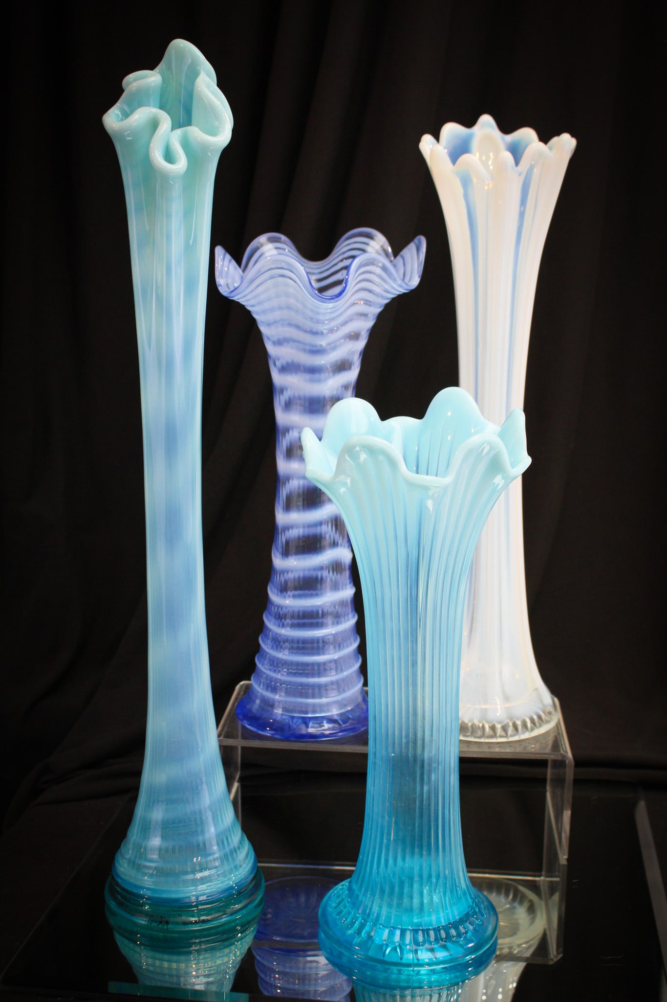 4 pc Lot Victorian Opalescent Glass Swung Vases: Four fabulous finds in Victorian opalescent swung vases. Included in the lot is a Dugan Plain Panel in white, a Ripple in blue, a Thin Rib in blue, and completed by a Ribbed Spiral in blue. Tallest me