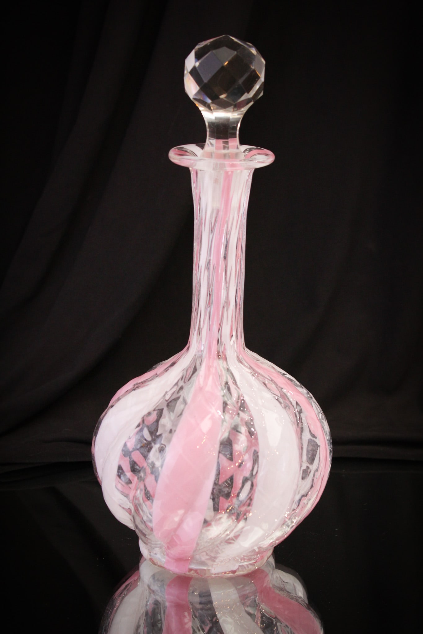 Phoenix Pink & White Diamond Quilt Wide Stripe Decanter: Beautiful and scarce form to find a piece of attributed to Phoenix Diamond quilt wide stripe pattern. His a sleek form bulbous base twist mold. Beautiful cut faceted stopper. Decanter measures 10 3/4"