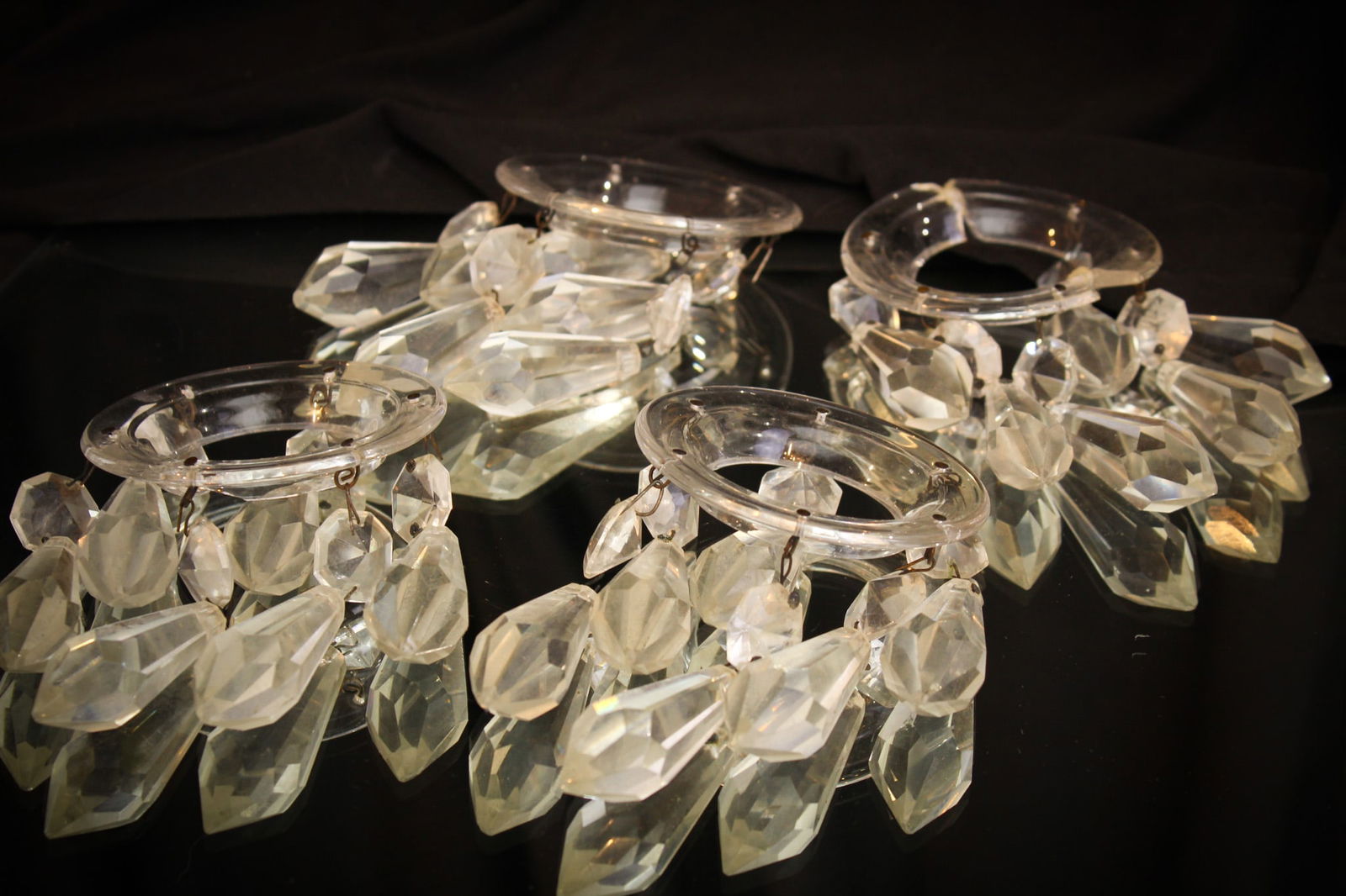 4 pc Lot Pairpoint Glass Bobeches & Cut Prisms: Select offering of a four piece lot of Pairpoint bobeches along with prism accents. Each measures 2 1/2" long. It is noted to bobeches with repaired hairlines.