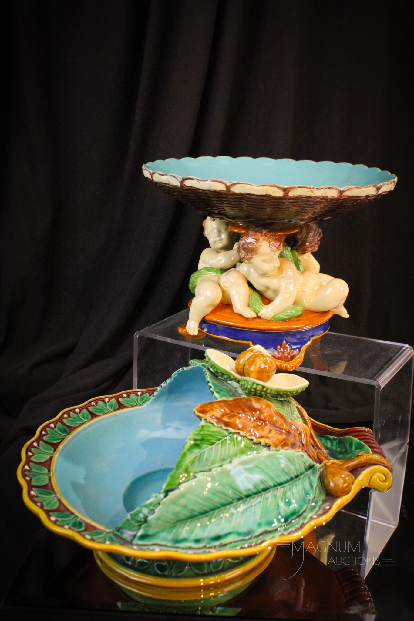 2 pc Lot Majolica: Two fine pieces of majolica in this generous offering. Featured is a triple cherub compote along with a walnut decorated nut bowl. Both pieces are unmarked.