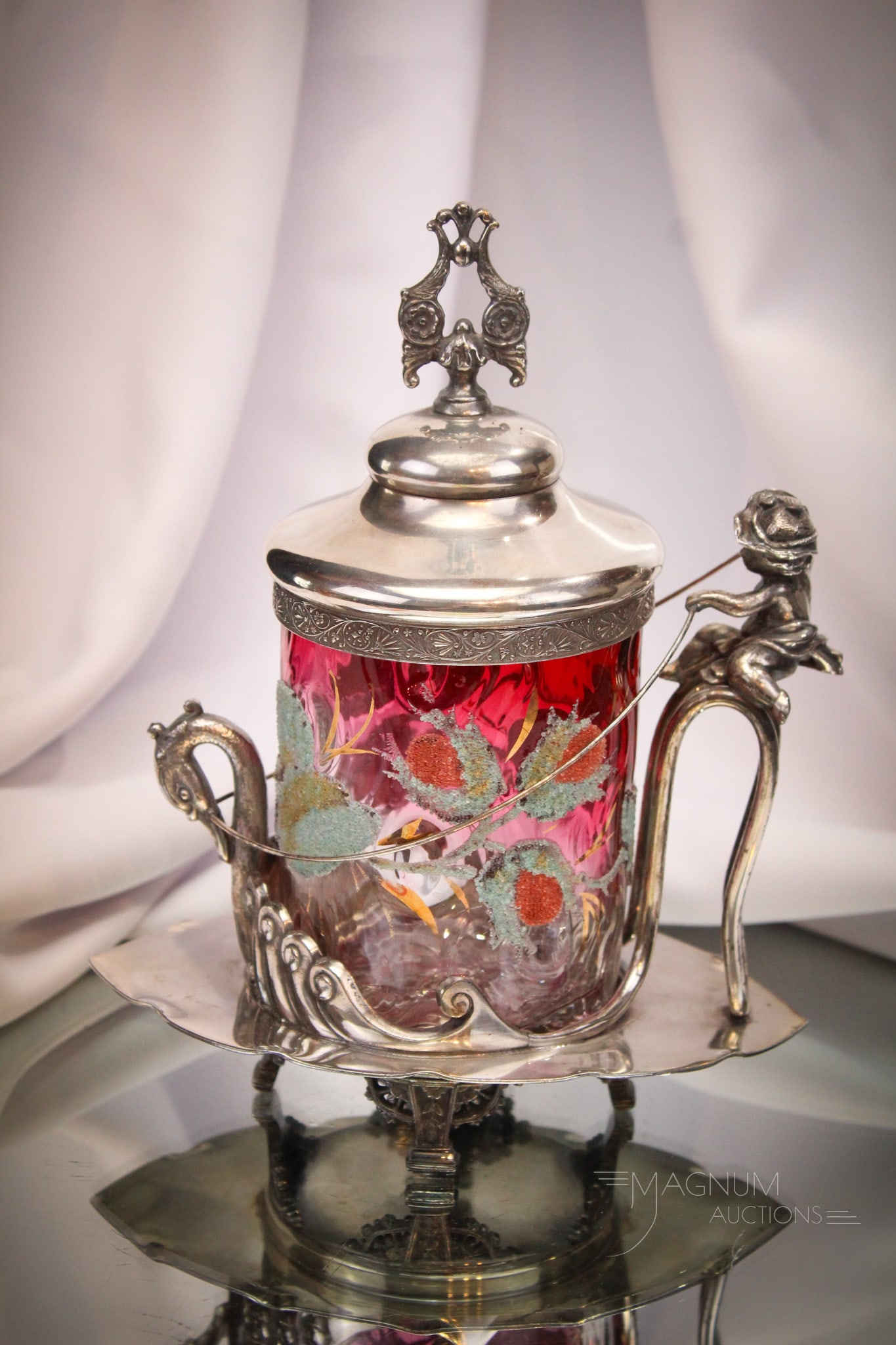Meriden Victorian Silverplate Cherub & Swan Figural Pickle Castor: Wonderful Victorian signed Meriden Victorian silverplate pickle castor complete with rubina tree bark optic glass insert. Insert is coralene decorated. Frame feaures a figural putti or cherub atop a s