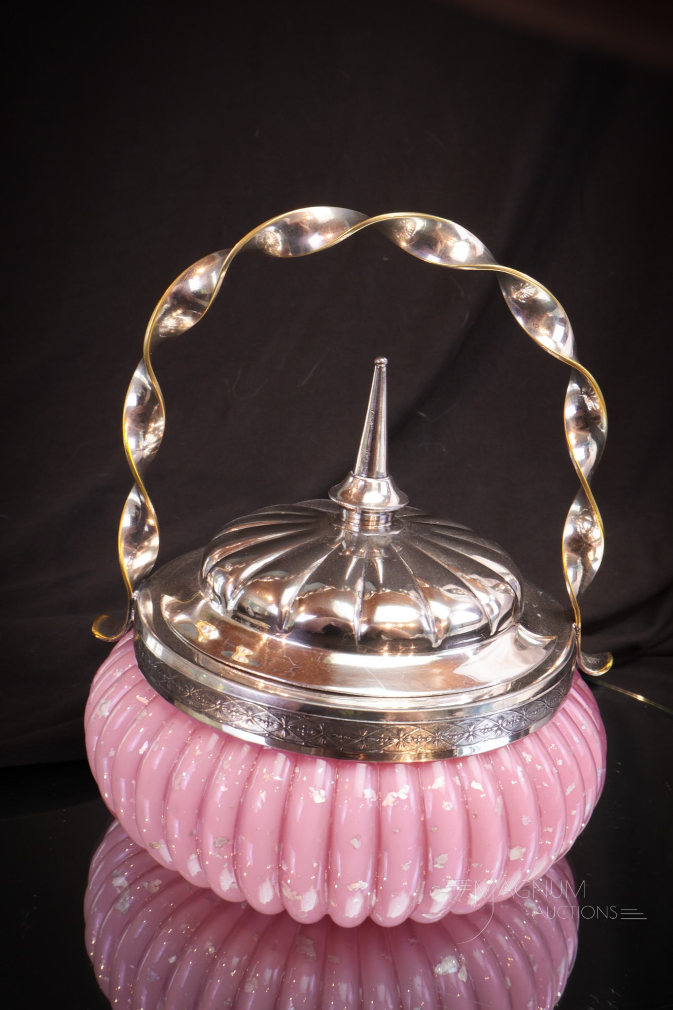 Victorian Silverplate Spangle Glass Melon Rib Sweetmeat: Pretty in pink Victorian spangle glass and silverplate sweetmeat. Piece has unique twisted handle and melon rib form body to the glass. Loads of silver mica in the spangle cased glass. Measures 5 1/2"