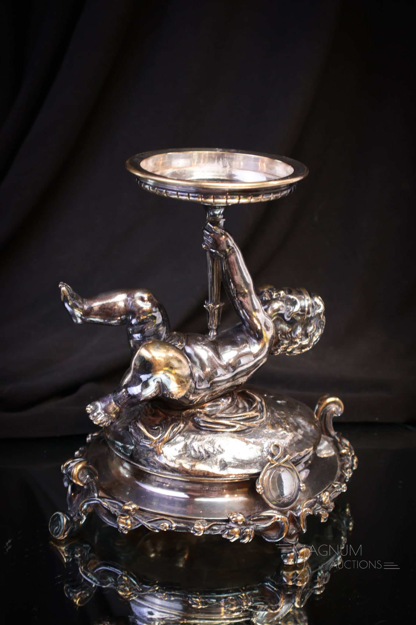 Christofle Silverplate Figural Putti Brides Bowl Holder: The best signed Christofle silverplate figural putti brides bowl holder. This ornate holder features a full figured putti holding up the support for the bowl. Fine offering that measures 6 1/2" tall,