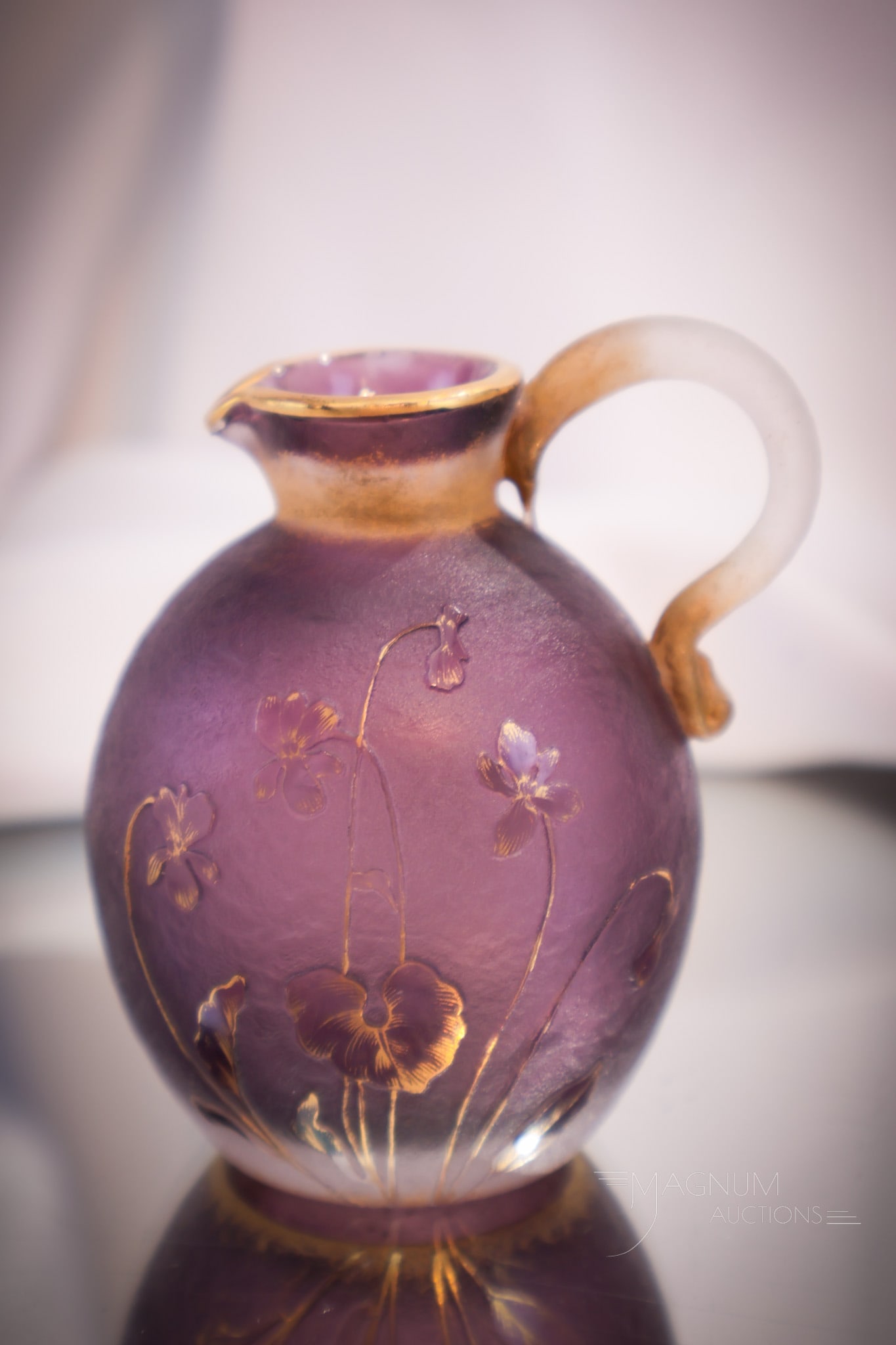 Daum Nancy French Cameo Art Glass Cruet: A great offering of this signed Daum Nancy French cameo art glass cruet. Fine purple coloring to the body with accented with gold flowers. Cruet lacking stopper. Measures 3 1/4" tall.