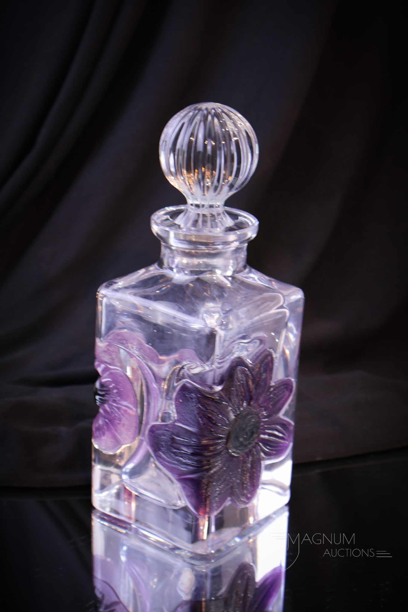 Daum France Pate De Verre Glass Perfume Cologne Bottle: Signed "Daum France" and marked BN on the base of the stopper Pate De Verre perfume or cologne bottle. This with accent of amythest colored flower. Measures 7 1/2" tall.