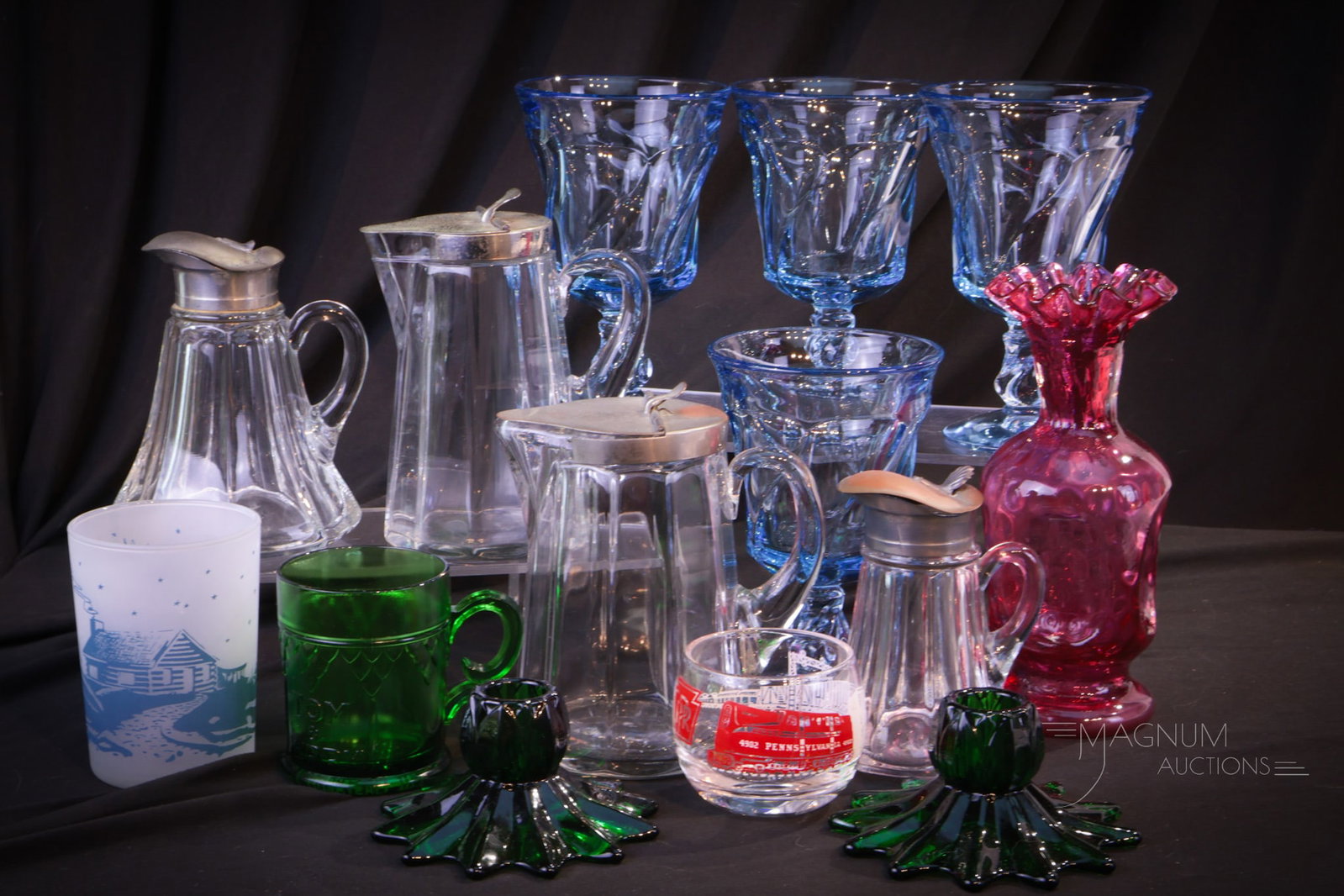 Magnum Auctions World Famous Goody Lot Fostoria Fenton & More Glass: A long awaited Magnum Auctions World Famous Goody Lot including Fenton, Fostoria glass, and more. Something sure to please in this generous offering. Tallest measures 7 1/4".