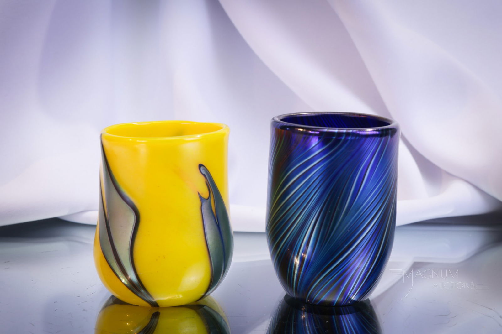 2 pc Lot Lotton Art Glass Toothpick Holders: Two special pieces to add to your collection. The first is an electric iridescent feather example signed, "Daniel Lotton, 1997." The second is a yellow with blue abstract design signed, "Charles Lotto