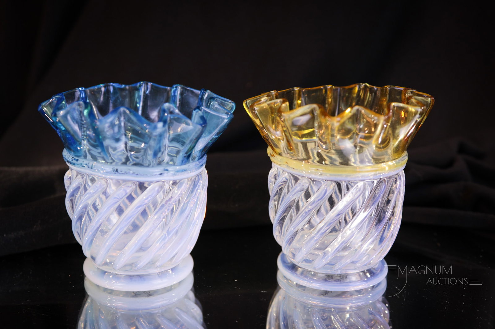 2 pc Lot Gonterman Swirl Amber & Blue Opalescent Victorian Toothpick Holders: Two selections in Gonterman Swirl opalescent toothpick holder in this lot. One in amber opal and the other in blue opal. Both fine examples. Each measures 2 1/2" tall.