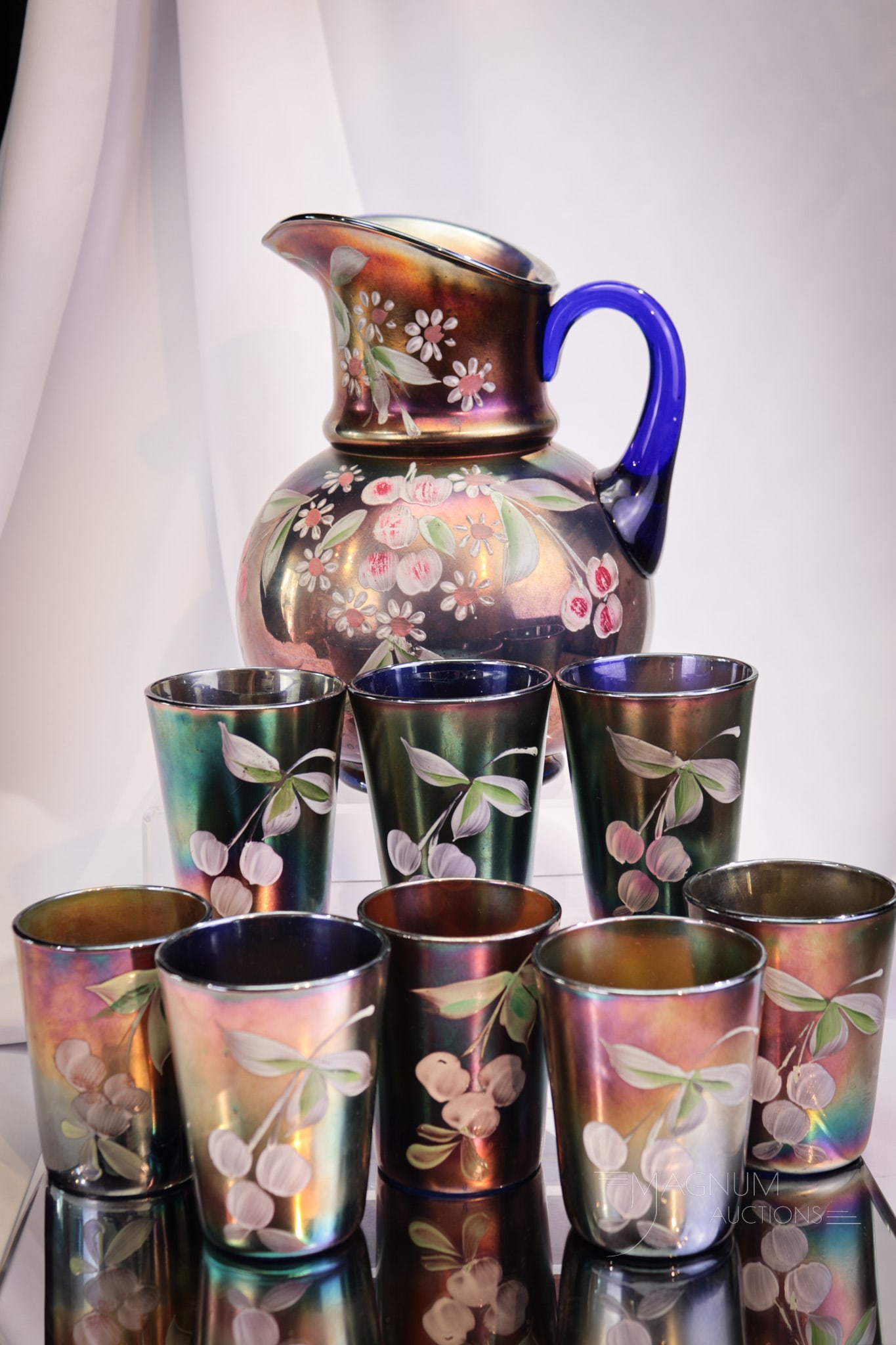 Fenton Blue Carnival Enameled Cherry 9 pc Water Set: How about this Fenton blue enameled cherry water set? This fine set is complete with eight tumblers. Bountiful plump and ready-to-be-picked cherries make up the enameled decoration. Nice coloring. Pit