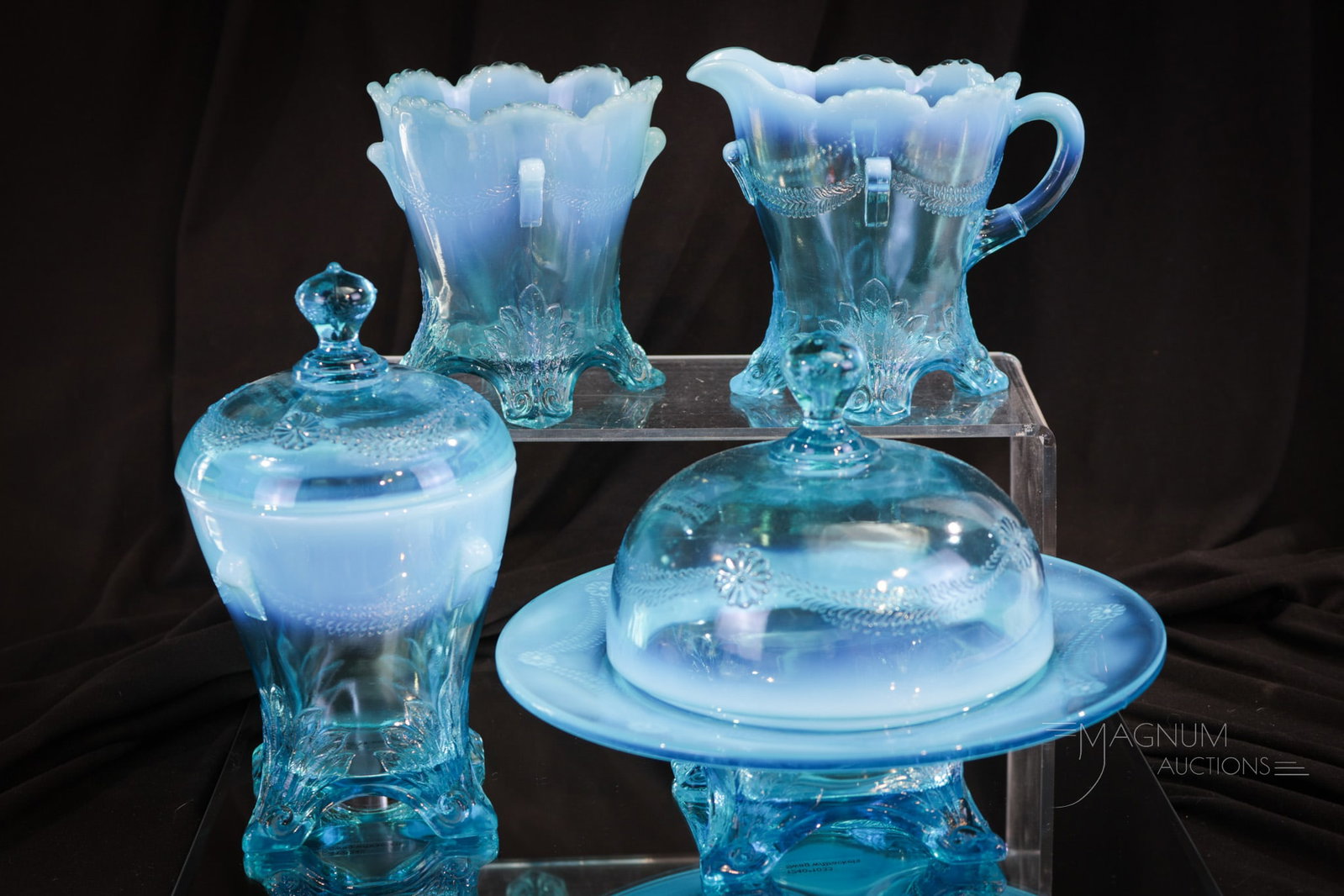 Jefferson Glass Swag with Brackets Blue Opalescent Glass Table Set: Wonderful blue opalescent Jefferson glass Swag with Brackets table set. Set consists of butter, covered sugar, creamer, and a spooner. Tallest measures 6 1/2".