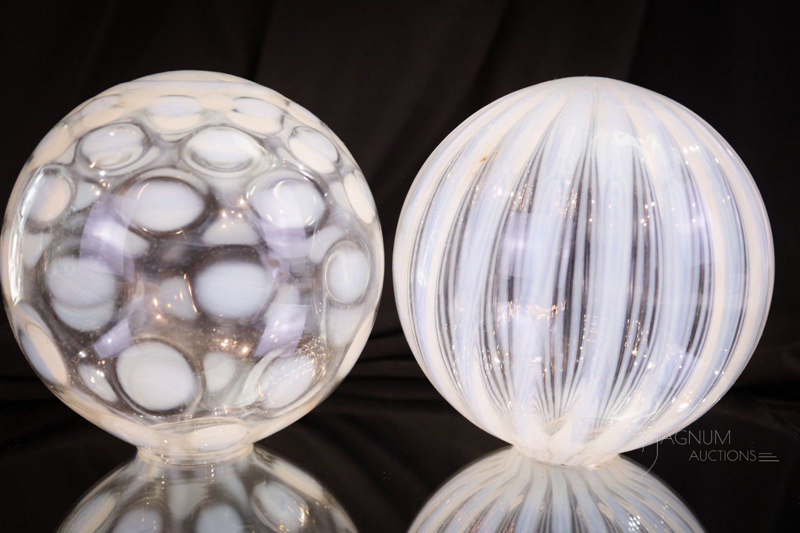 2 pc Lot Opalescent Victorian Glass Witch's Balls: Two decorative opalescent witch balls in this lot. Lot is comprised of a stripe and coin spot example in big ball mold. Who couldn't use a pair? Largest measures 4 1/2" tall.