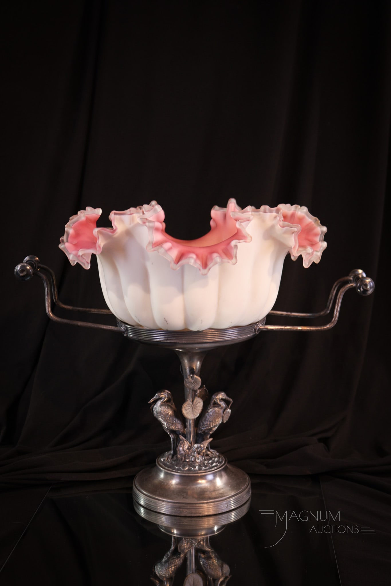 Reed & Barton Silverplate Figural Cranes Uranium Glass Brides Bowl: Fine and desirable uranium-cased pink interior brides bowl set in a signed Reed & Barton silverplate Victorian holder complete with figural cranes at the base. Deeply ruffled rim on the bowl. Complete