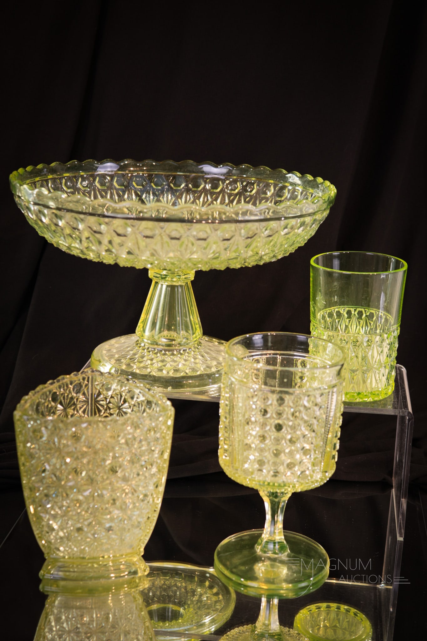 4 pc Lot Vaseline Victorian Pattern Glass: Four fun finds in the ever popular Victorian vaseline glass. This lot is comprised of a Central glass pressed Diamond compote and tumbler, goblet and square sugar box. Tallest measures 6".