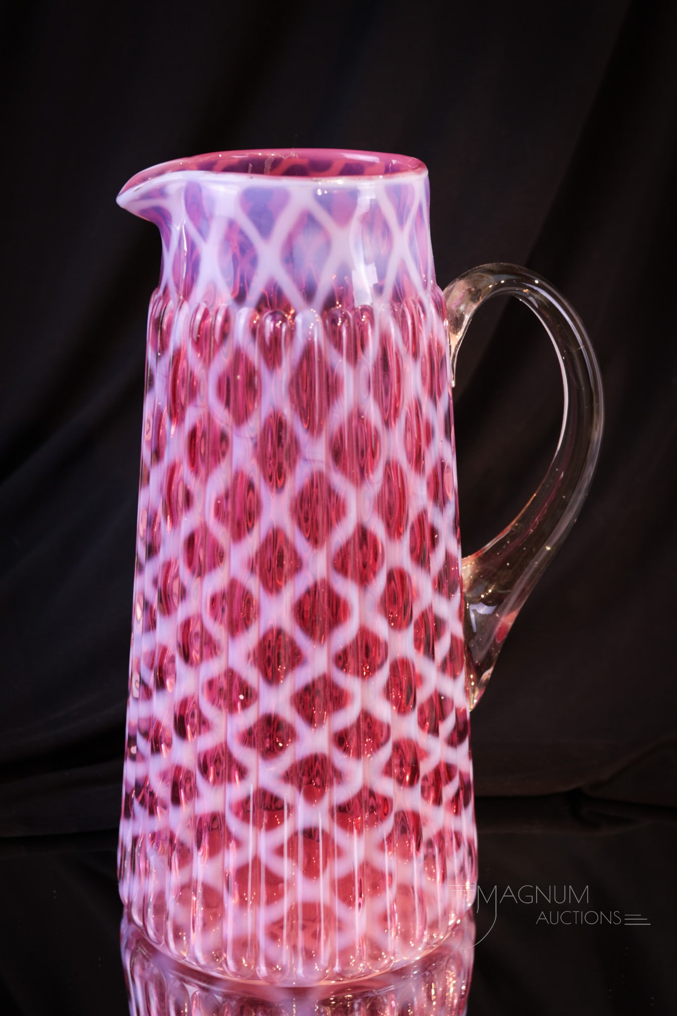 Northwood Cranberry Ribbed Lattice Victorian Glass Tankard Pitcher: Fine example of a classic Northwood tankard Victorian glass water pitcher. This pitcher has perfect color and bright crisp opalescence. It stands tall at 10 1/4". Provenance: This item is from the pri