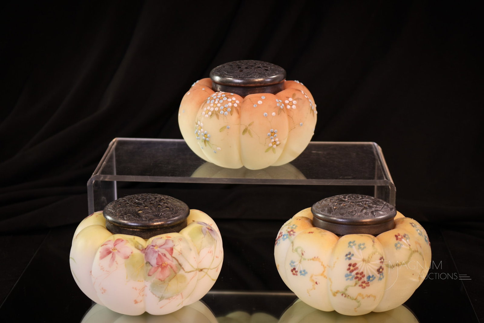 3 pc Lot Victorian Glass Mt. Washington Enameled Sugar Shakers: Three unique examples of Victorian glass sugar shakers. Each with a different coloring and floral decoration. All three to go together to a new home. Will the lot be yours? Each measures 2 1/2" tall.