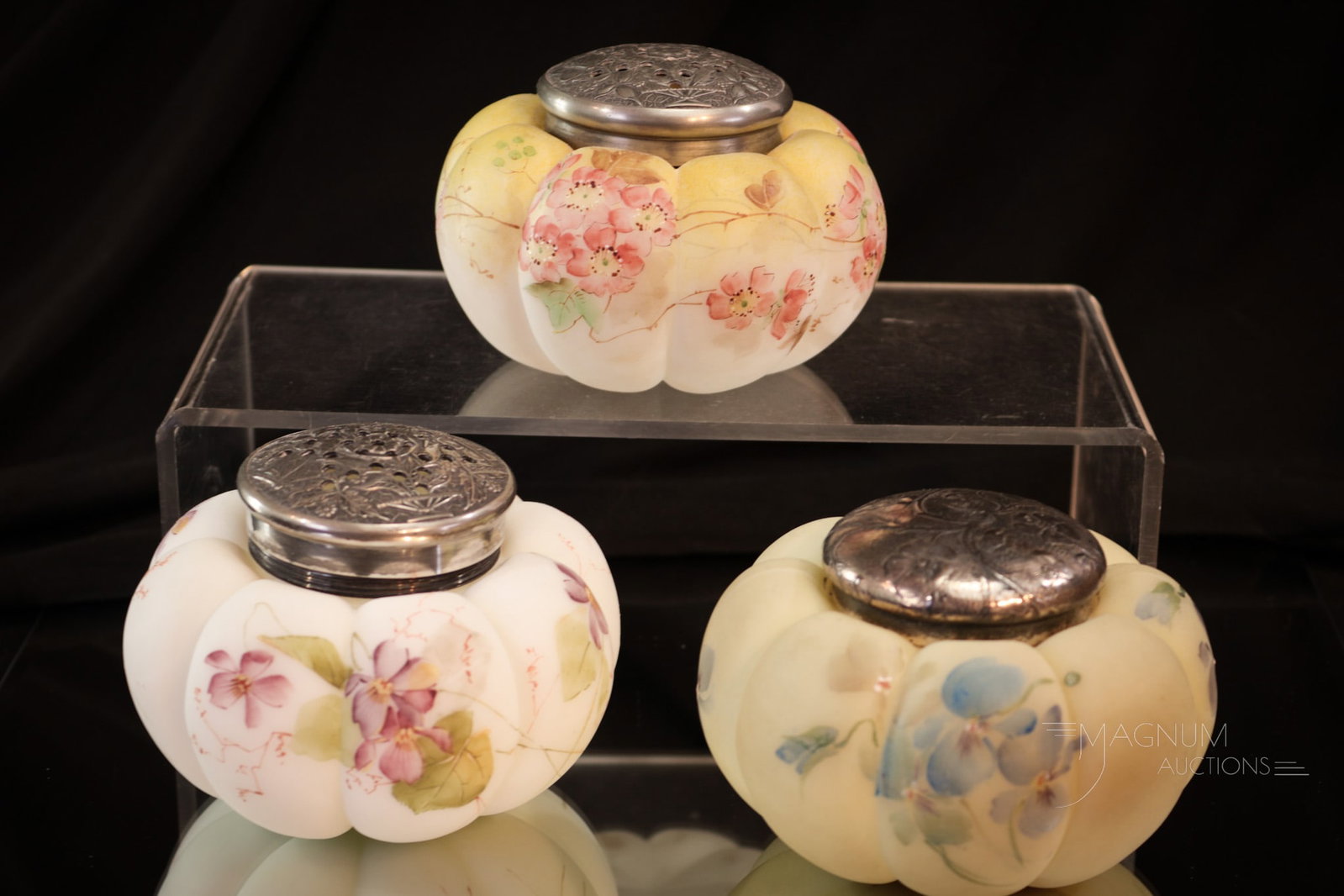 3 pc Lot Mt. Washington Glass Enameled Sugar Shakers & More: Three fine examples of Mt. Washington glass enameled tomato forms. Two sugar shakers along with a covered Bon-Bon jar. Each measures 2 1/2" tall.