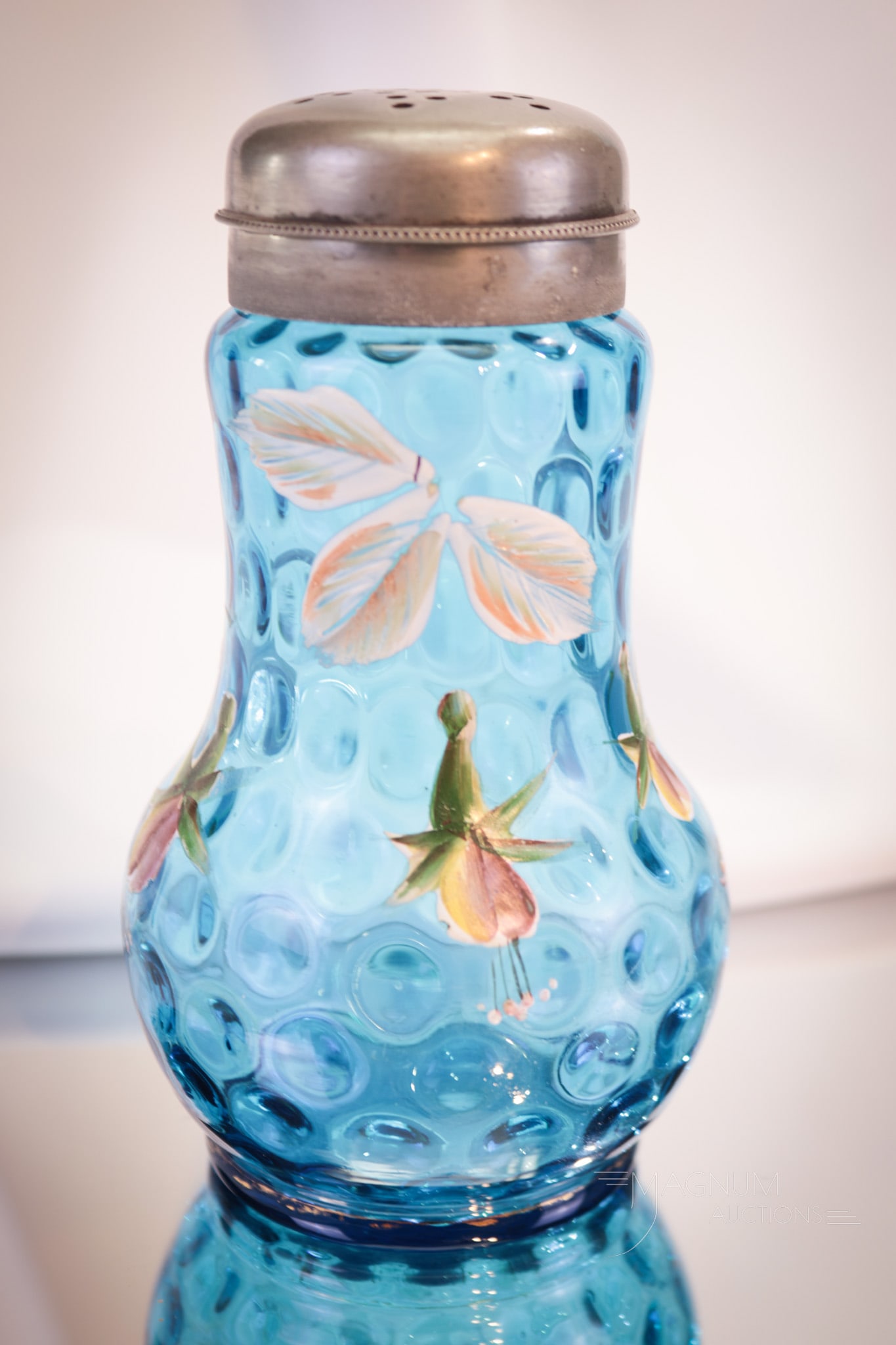Blue Enameled Victorian Glass Sugar Shaker: A beautiful Victorian glass sugar shaker enameled with florals around the body. This magnificent piece is a welcome addition to any collection! Shaker measures 5 3/4" tall. Provenance: This item is fr