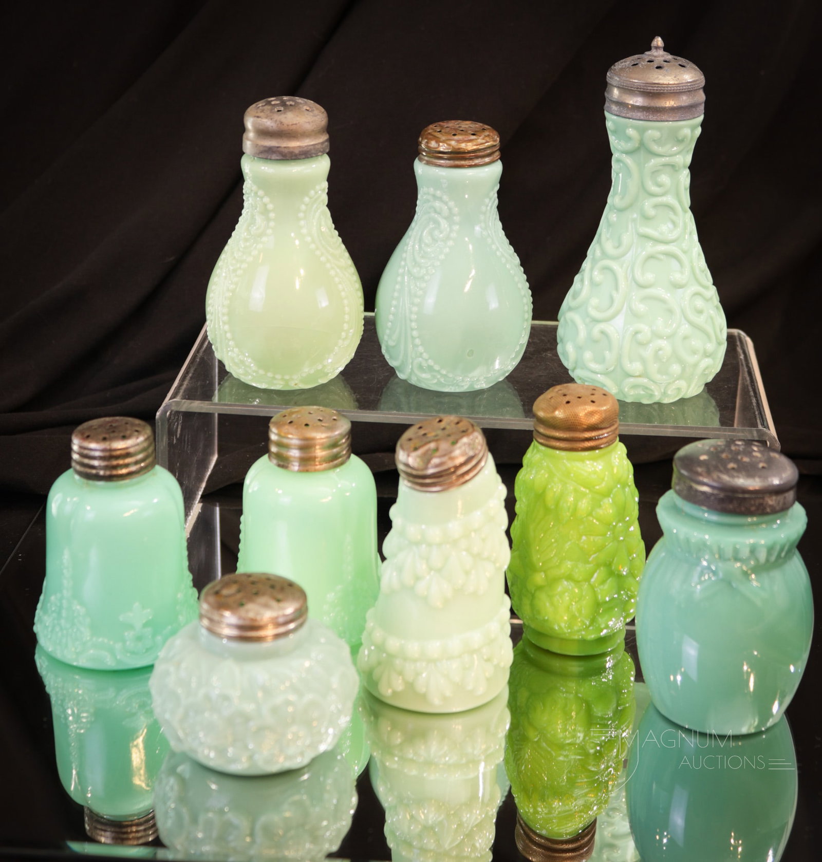9 pc Lot Victorian Glass Salt Shakers: Nine prizes among Victorian glass salt shakers makes up this lot of green. One as nice as the next. Four of these wonderful shakers make up matched pairs. Tallest measures 4 3/4".