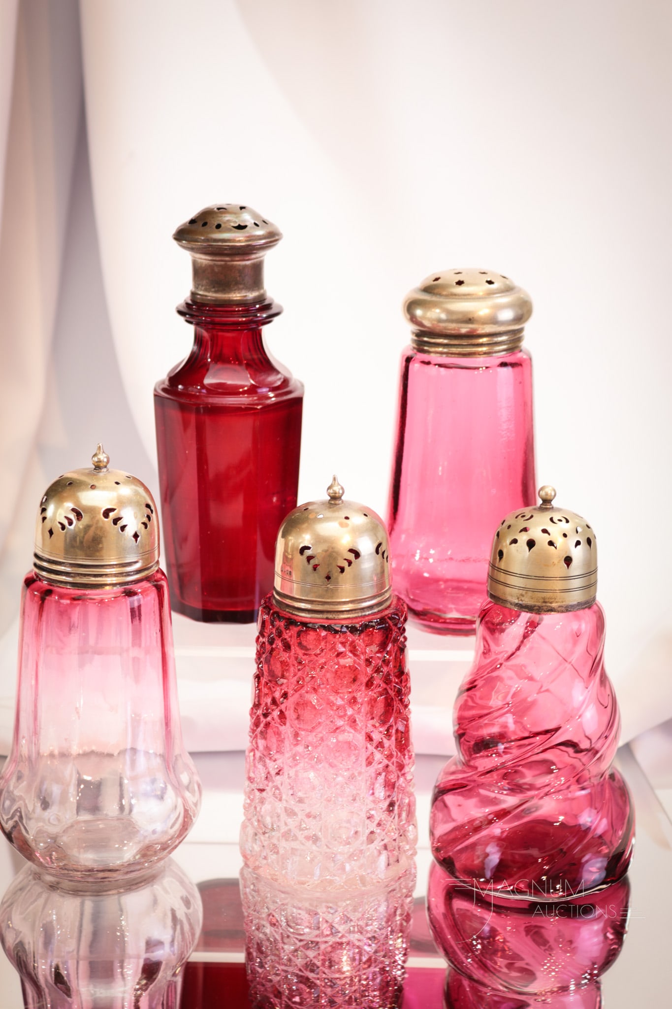 5 pc Lot Cranberry Victorian Glass English Sugar Shakers Muffineers: Five selections in English cranberry Victorian glass sugar shaker or muffineers that are sure to please. This lot has a variety to make it collection enhancing for you. Some delights for sure! Tallest