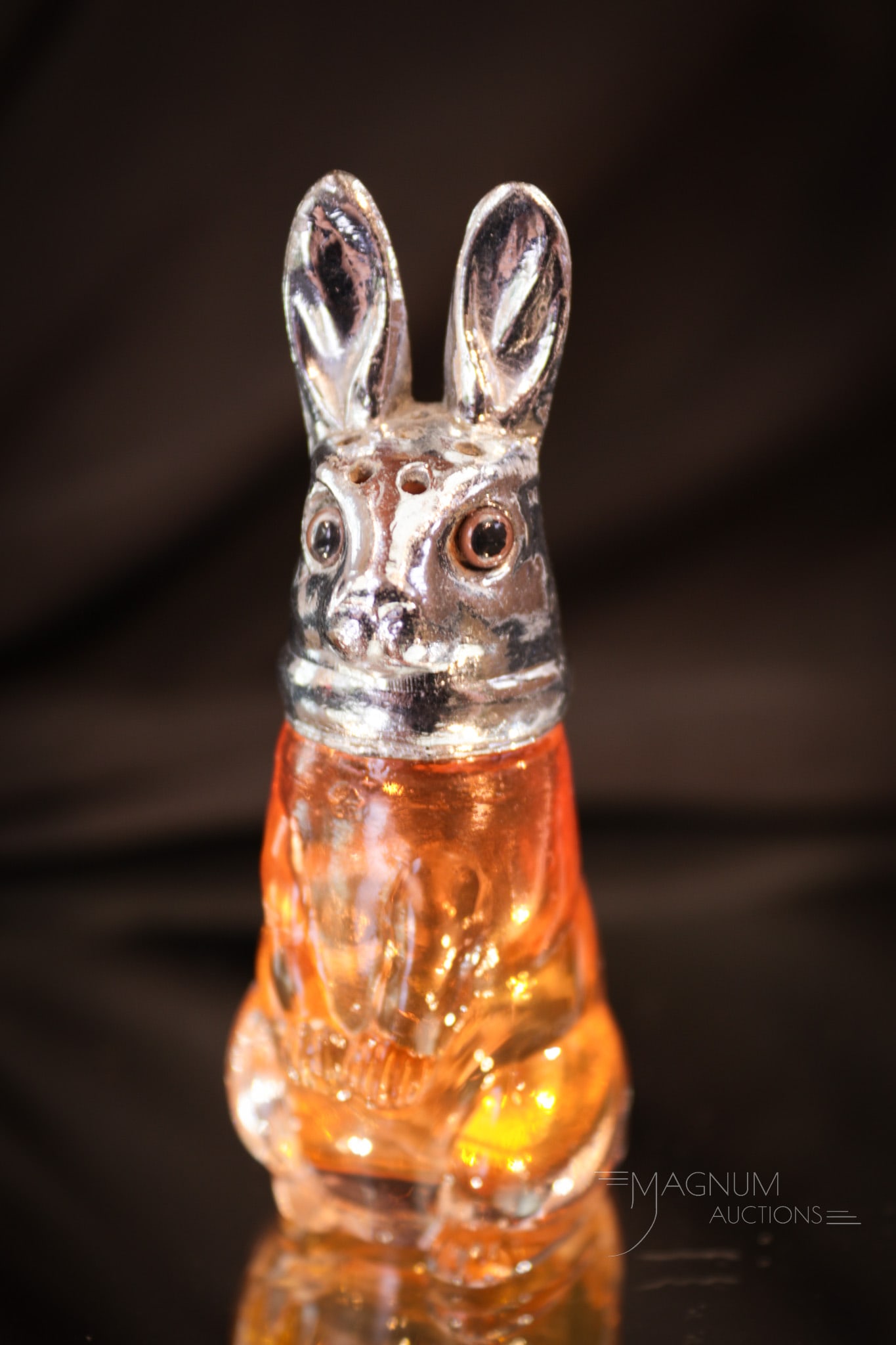 Rare Rabbit Figural Glass Salt Shaker: What a find! This rare rabbit salt shaker is in a rosey amber glass. Complete with the original metal lid. Shaker measures 3 1/4" tall.