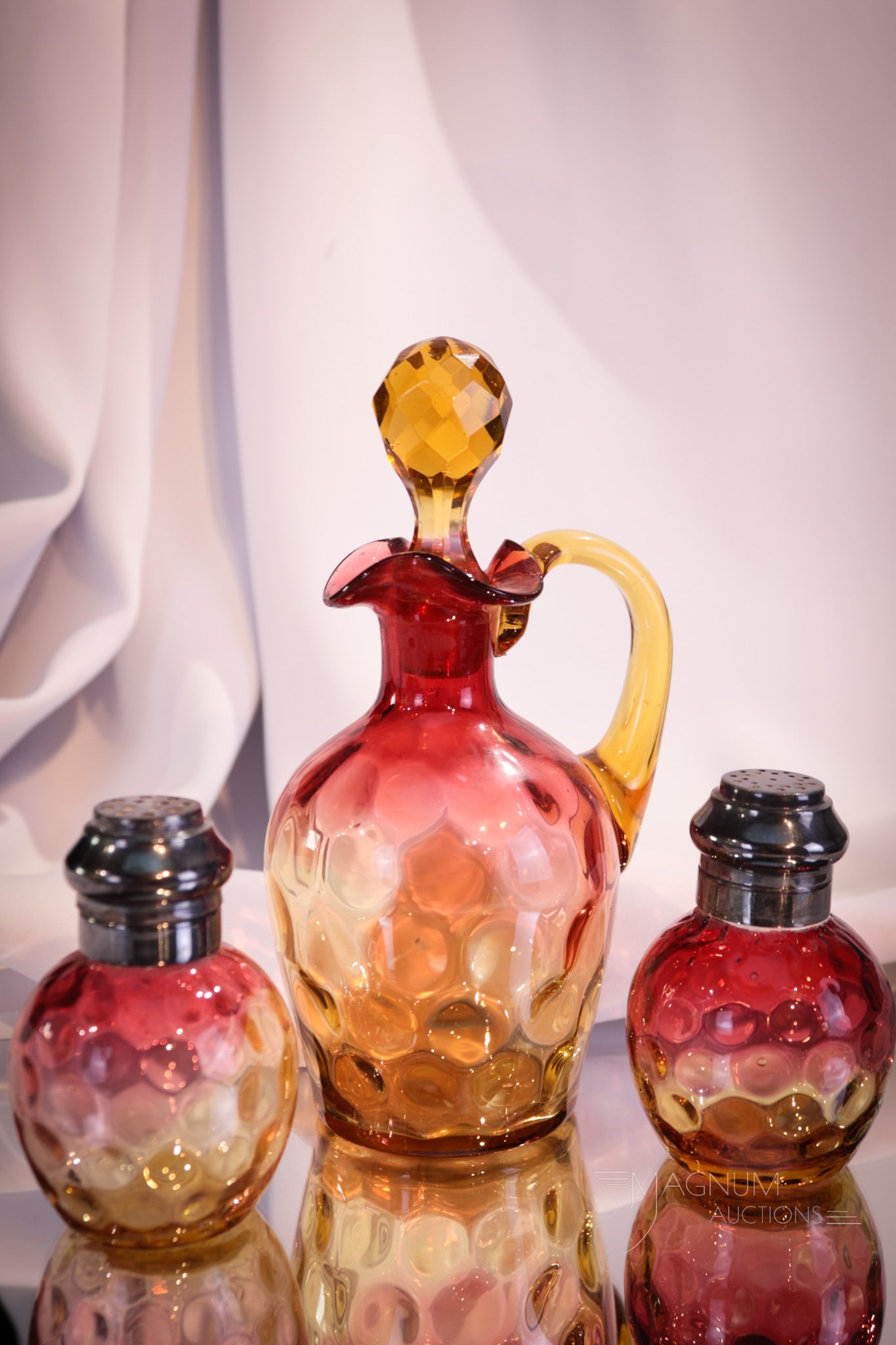3 pc Lot Victorian Amberina Glass Cruet & Salt Shakers: A very nice trio set comprised by a cruet and matching shakers. Cruet features cut faceted amber stopper. Very nice offering. Tallest measures 6 1/2" tall.
