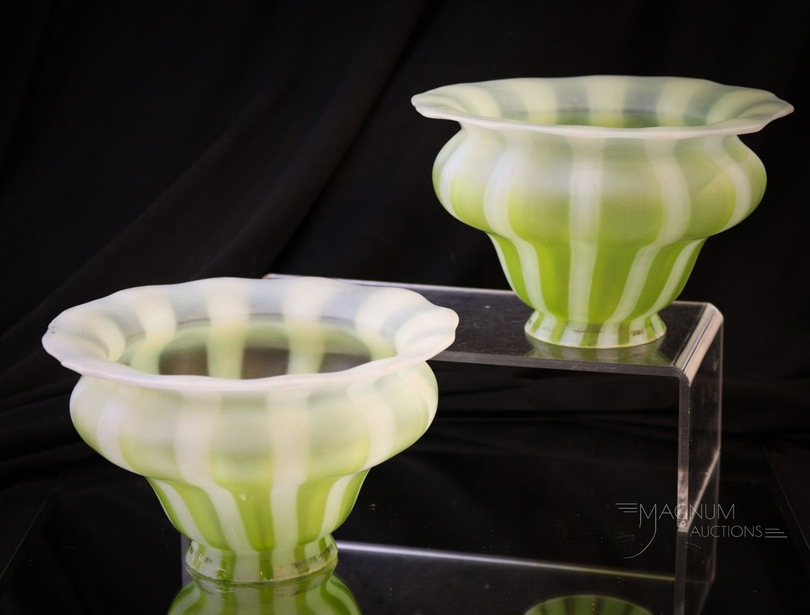 Pair Lime Green Opalescent Stripe Art Glass Shades: Fine pair of lime green opalescent stripe art glass shades in satin finish. Each shade measures 3 1/2" tall, 6" wide, with a 2 1/4" fitter.