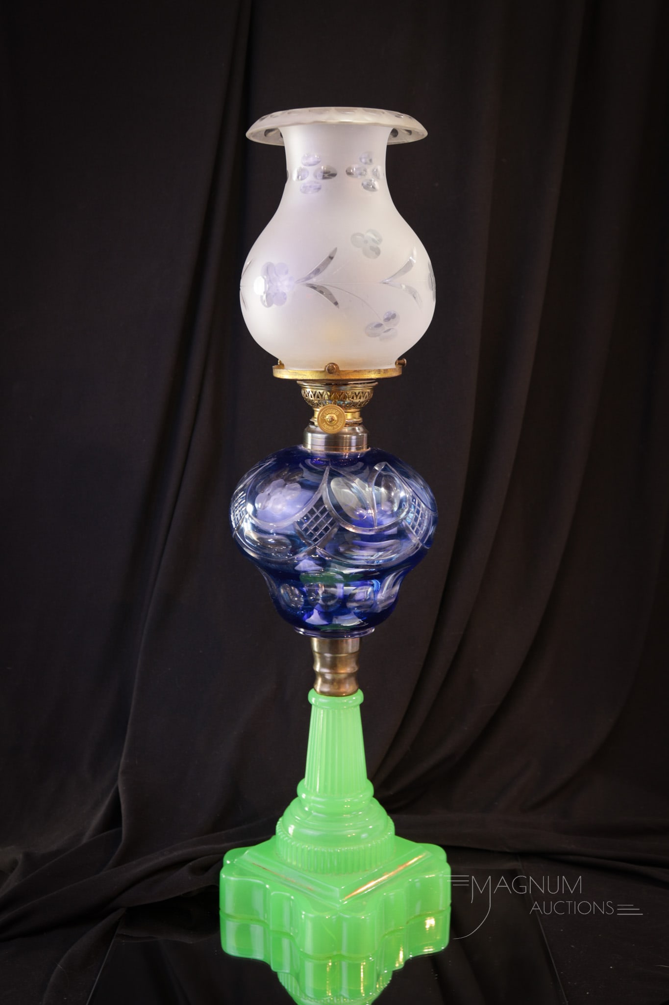 Blue Cut Overlay Victorian Jade Opaline Uranium Glass Oil Banquet Lamp: Striking Victorian blue cut overlay Victorian oil banquet lamp complete with jade-green opaline uranium glass base and clear cut etched shade. Lamp measures 22" tall. A very nice piece!