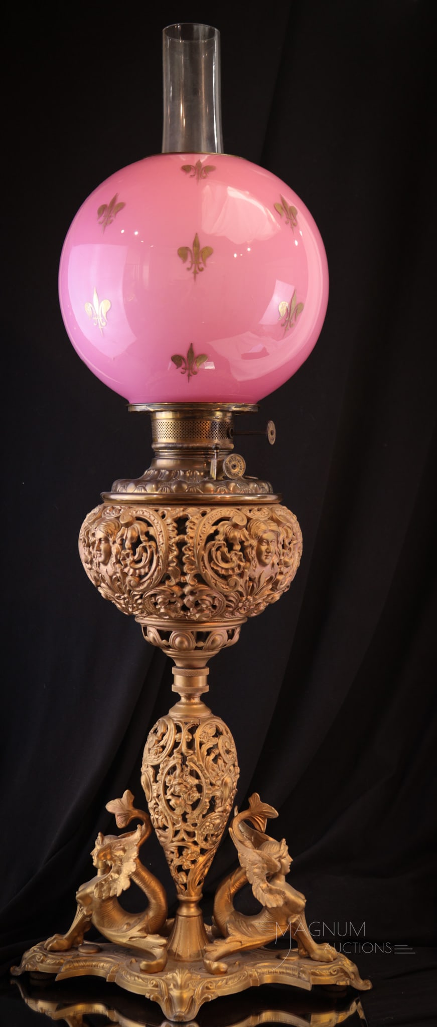 Victorian Sphinx Pink Cased banquet Oil Lamp: Great form to this sphinx adorned Victorian banquet lamp base. Each side having a figural sphinx and ornate font. Lamp is completed by a Victorian pink cased with gold fleur de lis decoration shade. L
