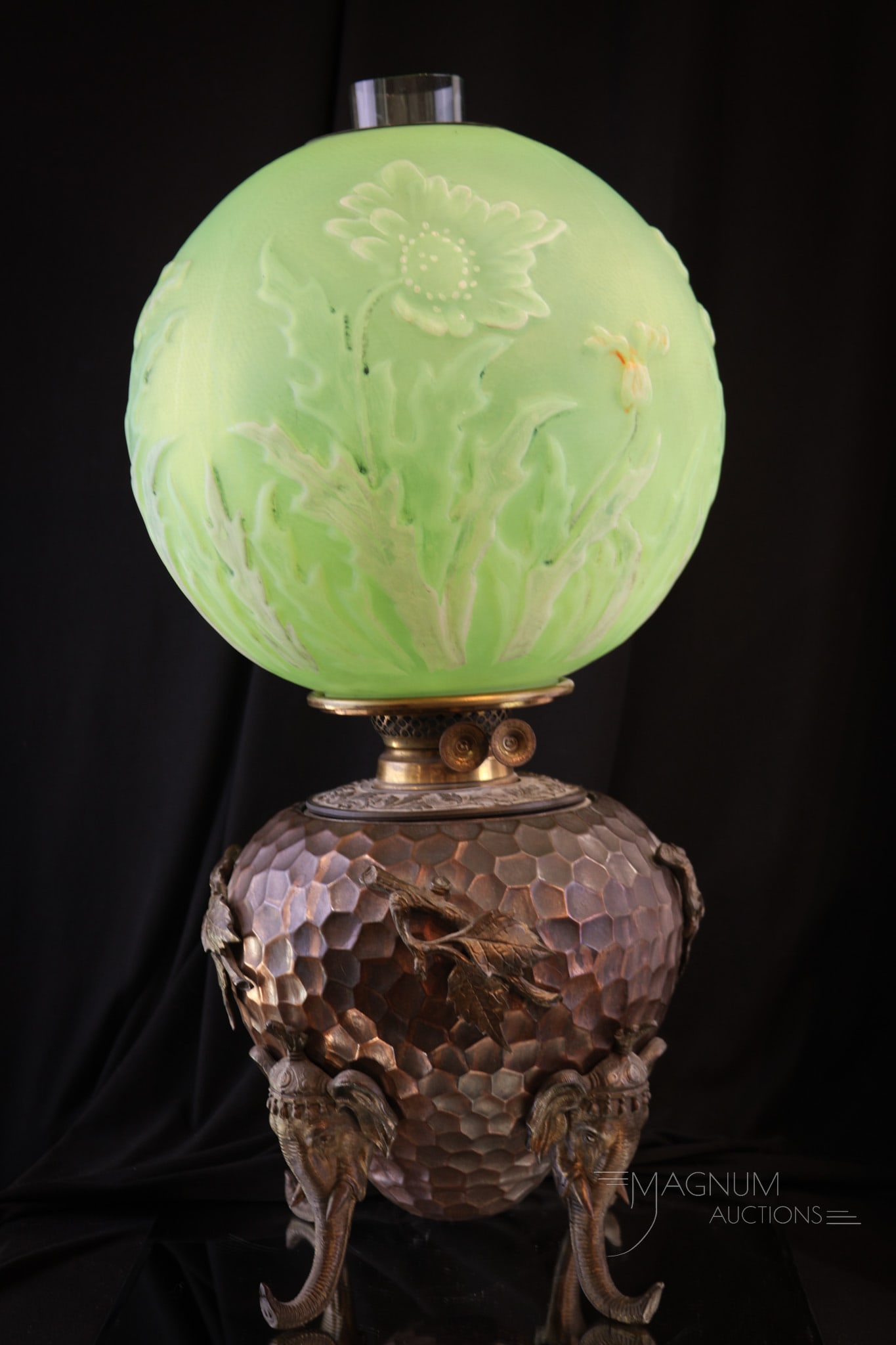 Victorian Circus Elephant Vaseline Uranium Glass Parlor Oil Lamp: A very rare lamp folks! This lamp features four circus elephant heads with trunks extended for legs. Font has a hammered appearance and ornate collar around the burner. Lamp is completed by a uranium