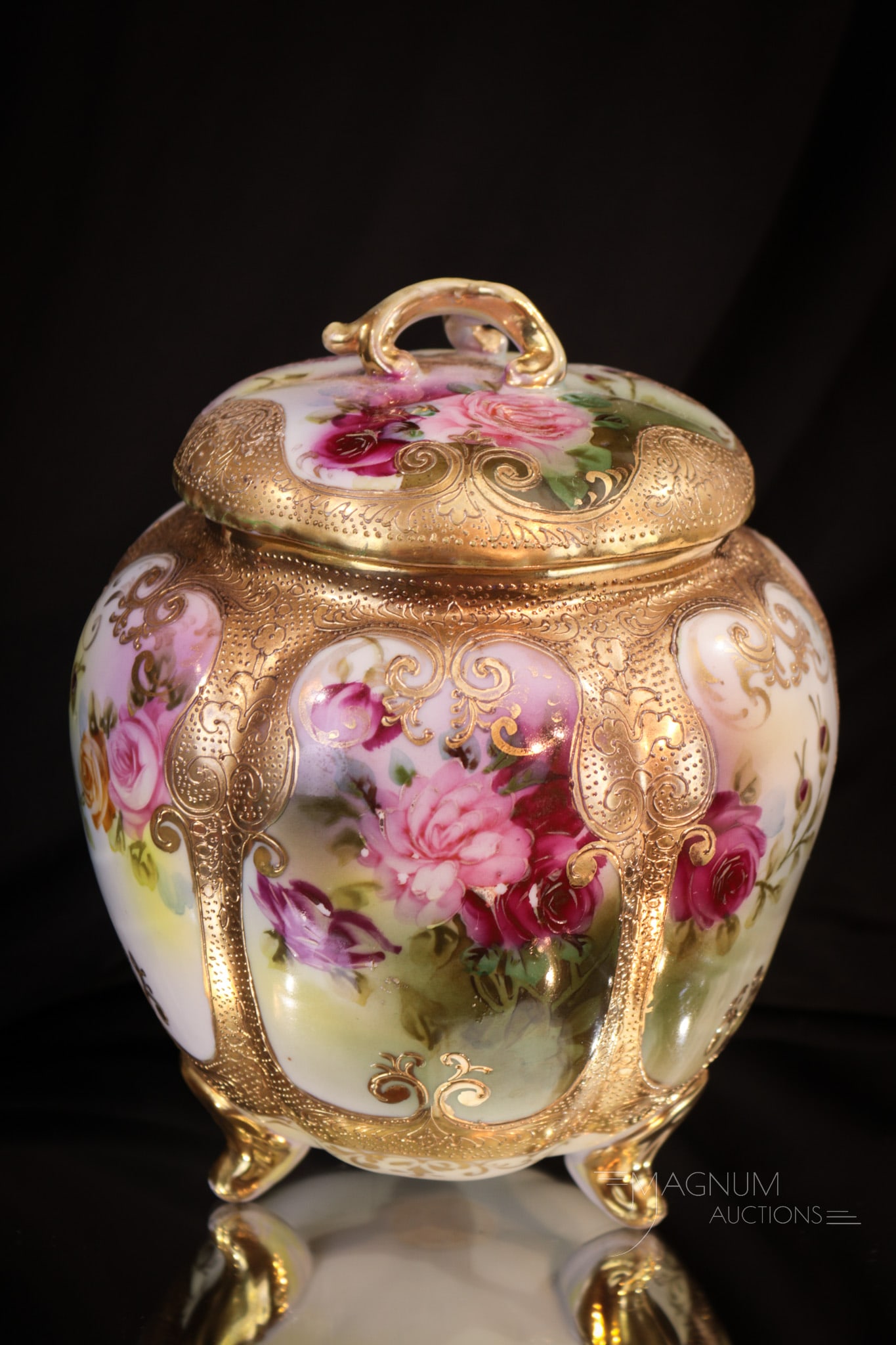 Unmarked Nippon Porcelain Roses and Gold Biscuit Jar: Fine unmarked Nippon biscuit jar decorated with lots of roses and gilt around the body. Complete with original lid. Piece measures 8" tall.