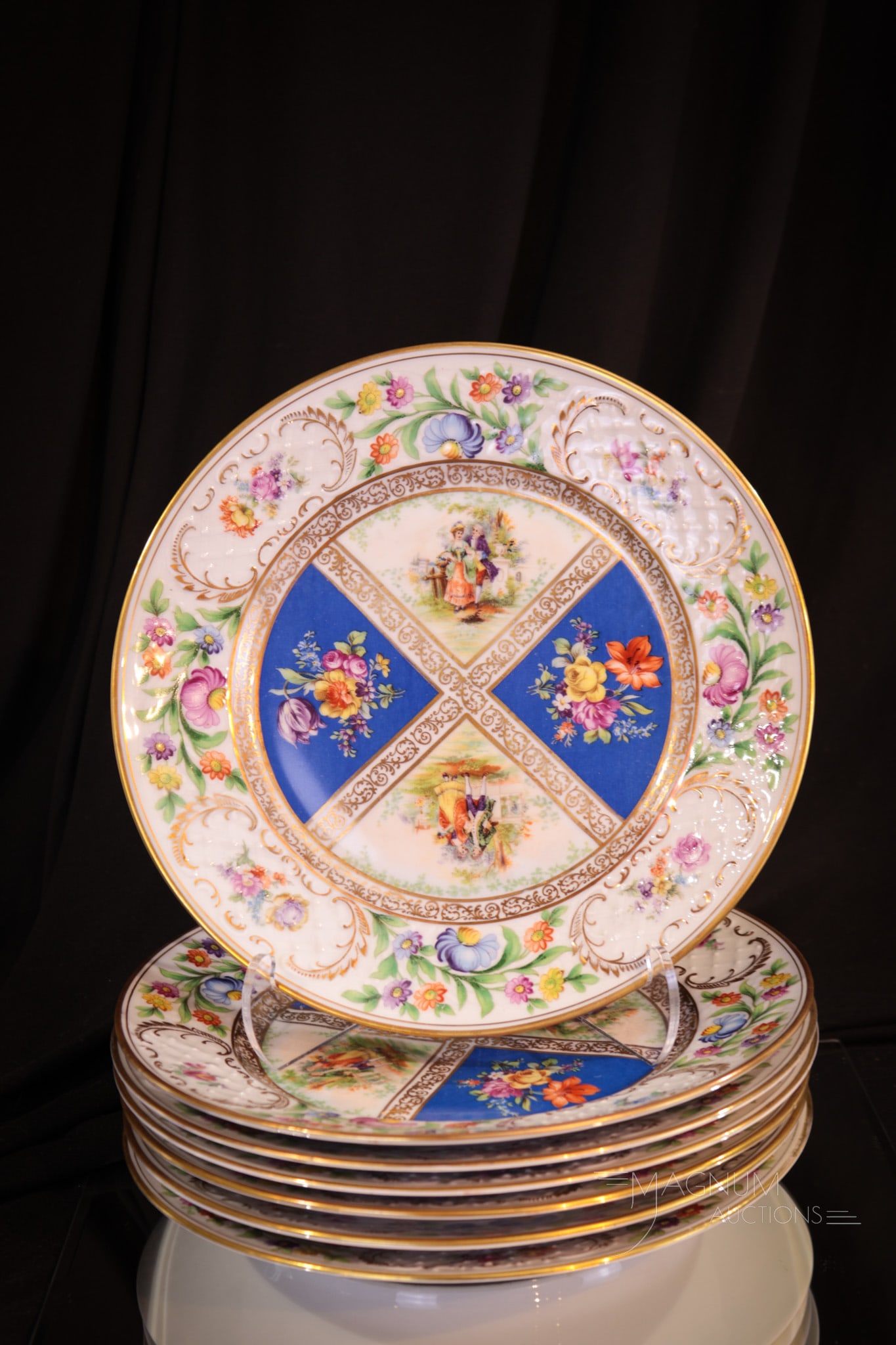 7 pc Lot Schumann Dresden Bavaria Dinner Plates: Select offering of seven Schumann Dresden Bavaria dinner plates with embossed lattice and floral bordering. All-over florals with courting couple as well. Each measures 9 1/2".