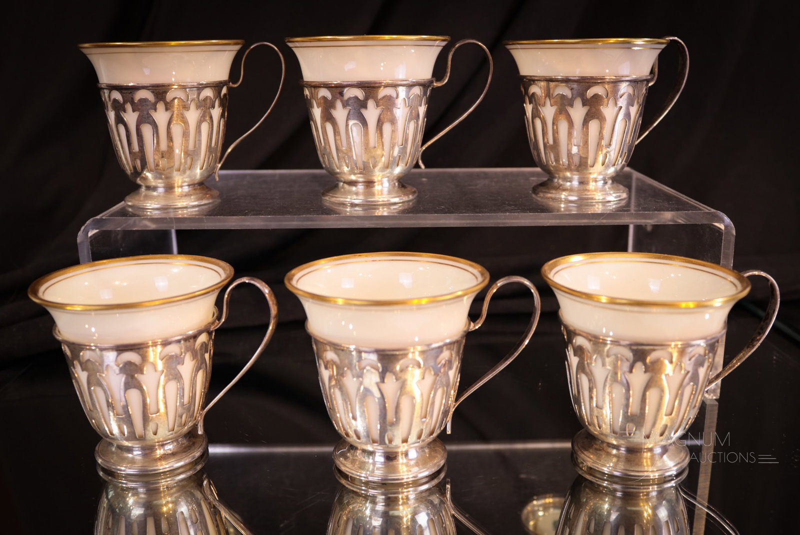 6 pc Set Sterling and Lenox Invory Gilt Porcelain Demitasse Cups: Very attractive Lenox ivory and gilt porcelain and sterling demitasse cups. Sterling weight is 4.6 ozt. Each measures 2 1/4" tall.