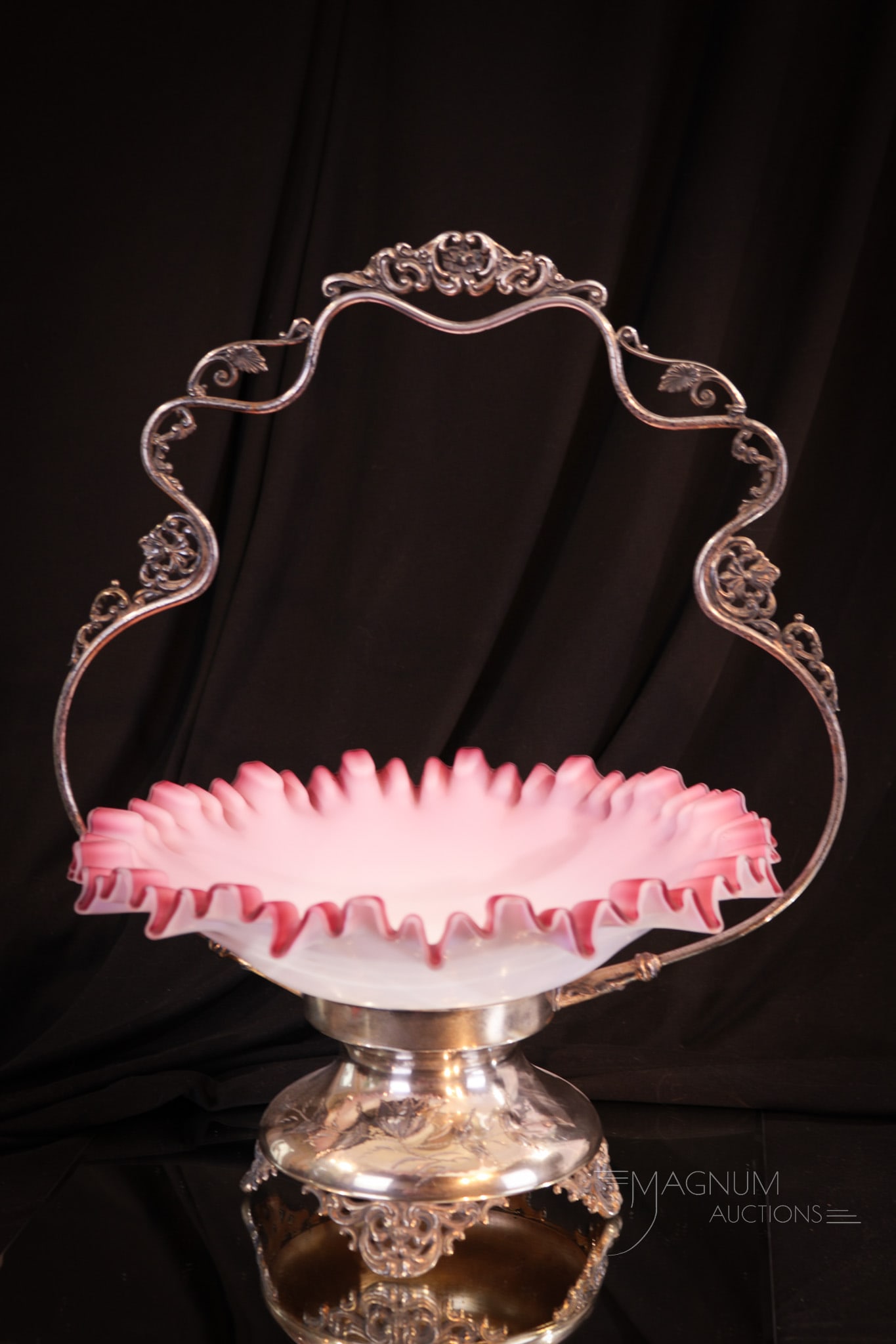Victorian Silverplate 16" Pink Cased Brides Bowl Basket: Impressive Victorian silverplate 16" tall brides basket complete with pink cased glass bowl. Nice piece of Victoriana. Basket is 12 1/2" wide. Illegible mark to silverplate.