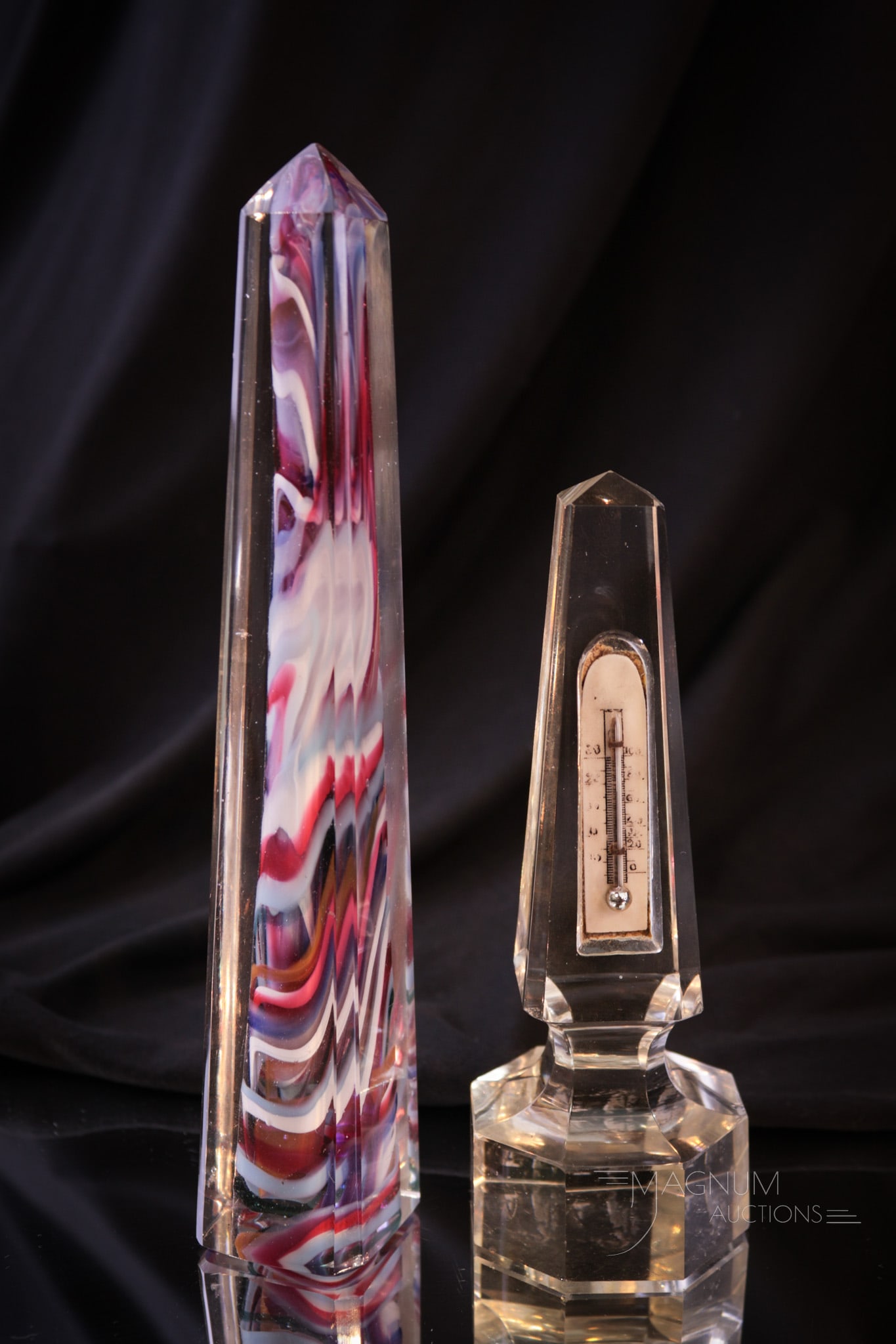 2 pc Lot Art Glass Obelisk Thermometer & Paperweight: Two wonderful and unusual art glass obelisks. One is a thermometer. The other a paperweight with injected color swirls in the body. Tallest measures 7 3/4".